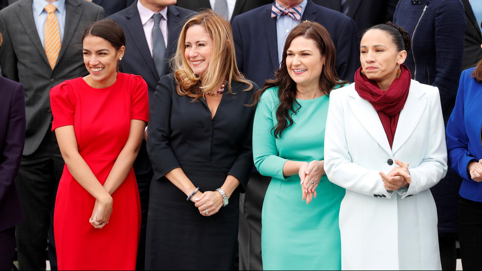 Four women are lined up for a group picture.