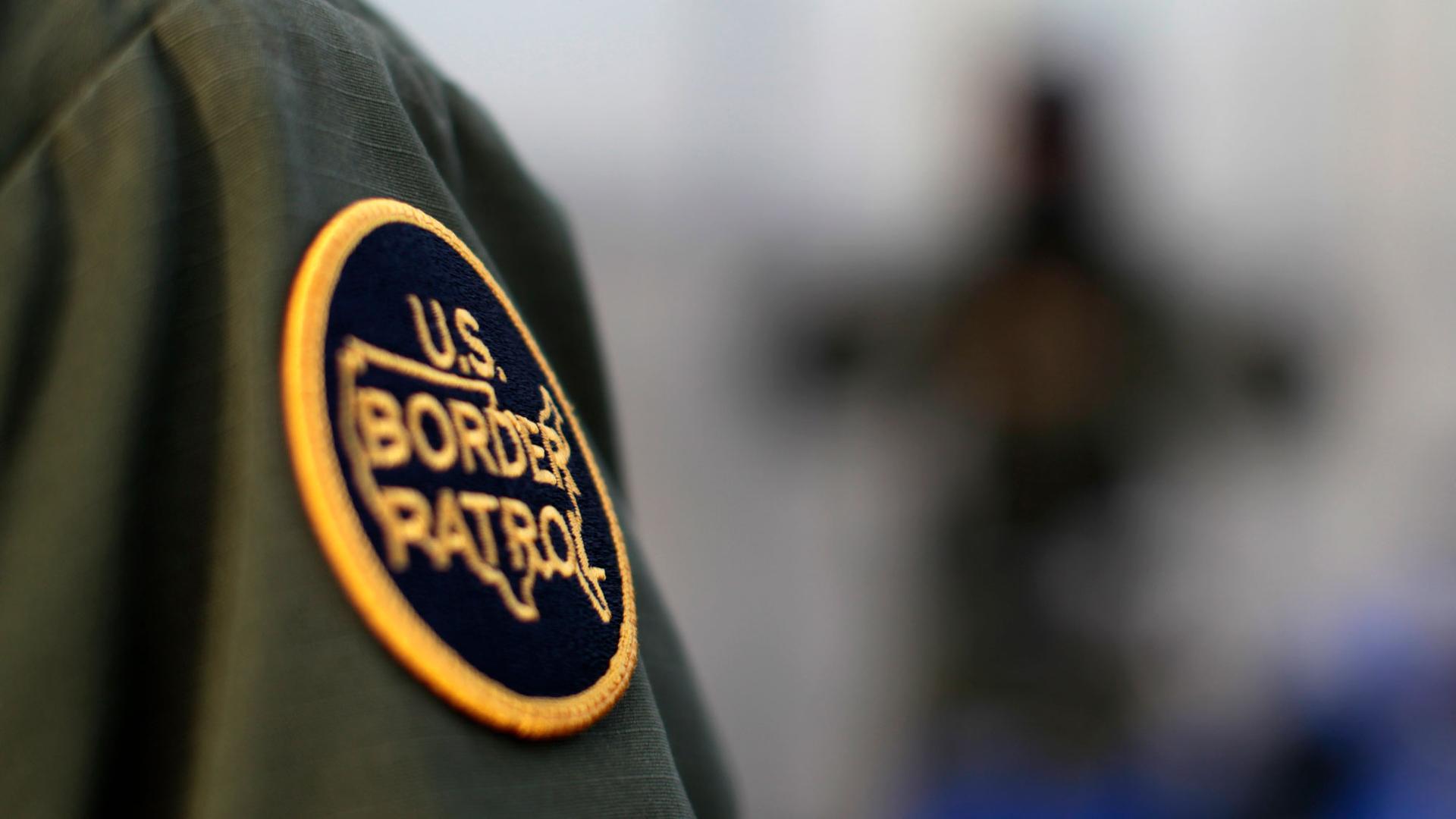 In this close-up photo, a logo patch is shown on the uniform of a US Border Patrol agent.