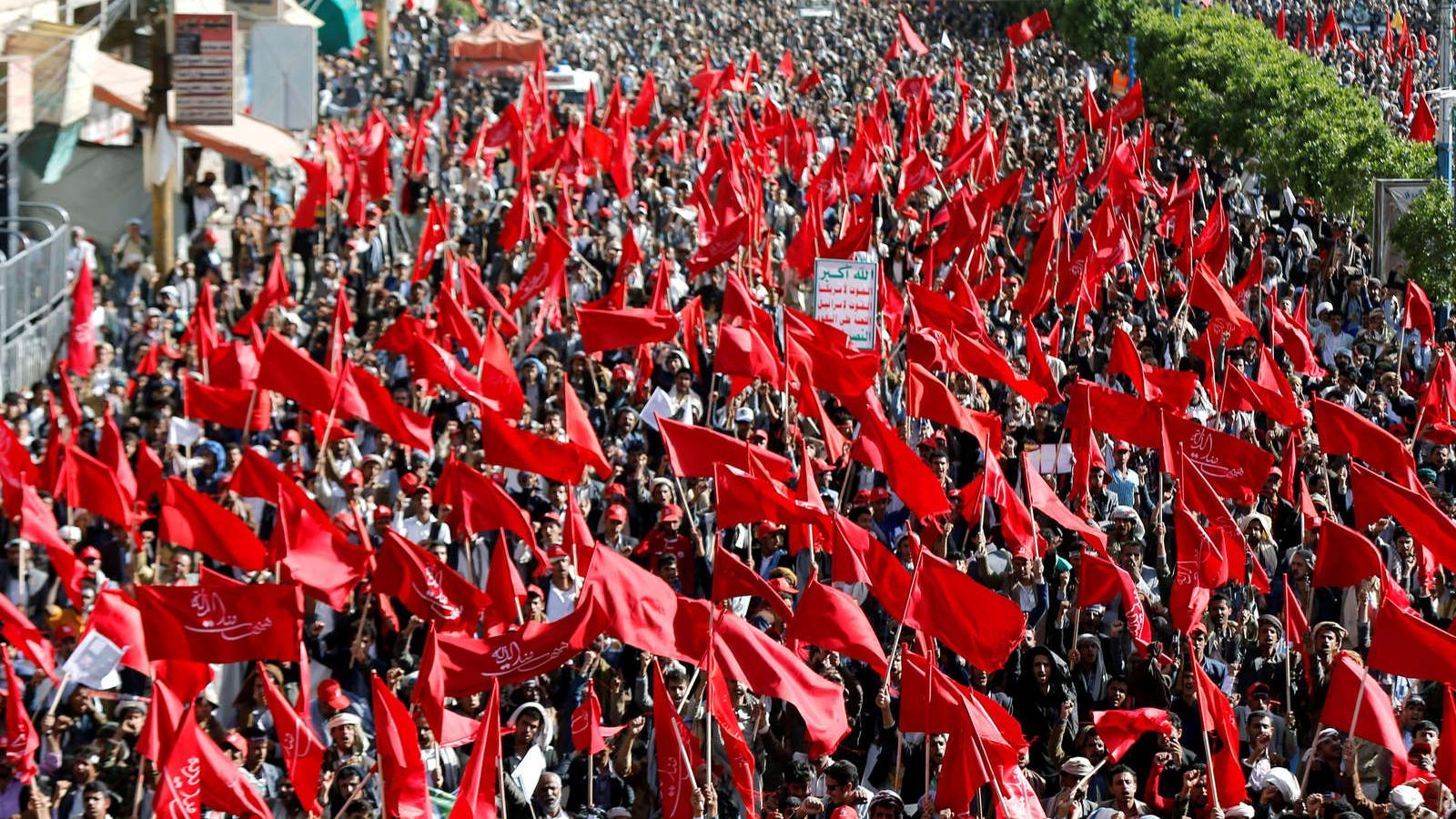 A sea of red flags wave as Yemeni Houthi protest. 