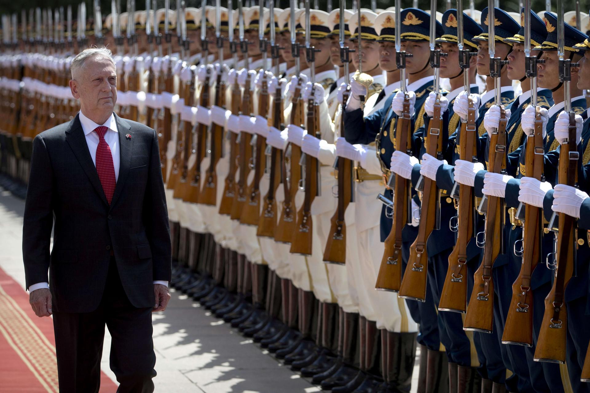 US Defense Secretary Jim Mattis walks past a row of Chinese soldiers 
