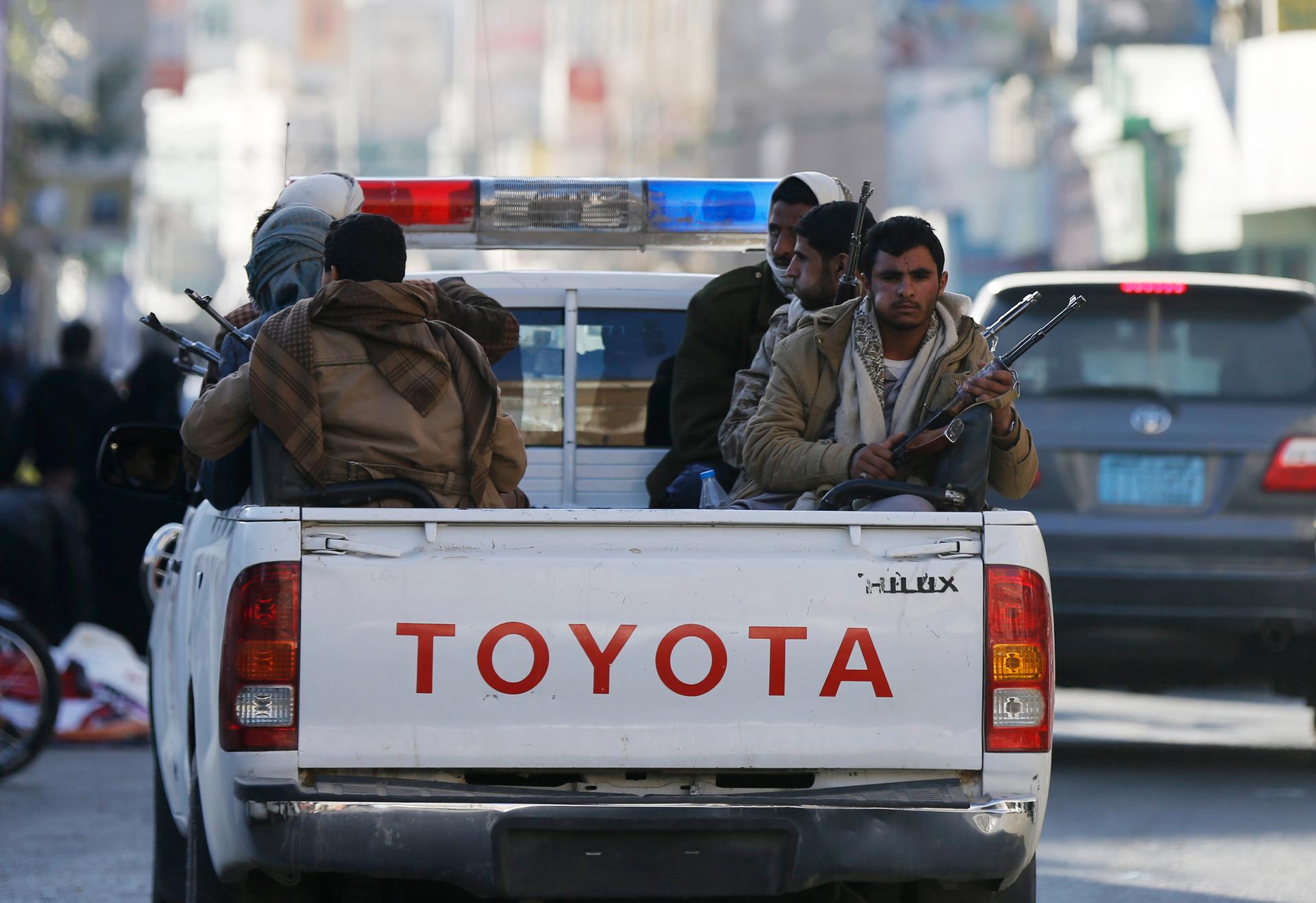 Houthi fighters ride in a truck on a street leading to the Republican Palace in Sana'a, Yemen, on January 20, 2015. 