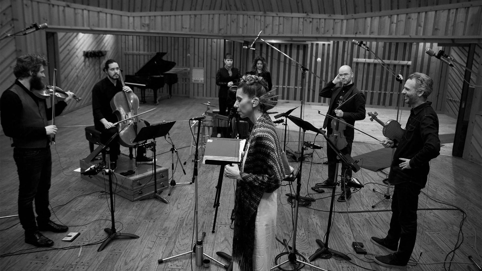 a black and white Herrera and her band in a recording studio 