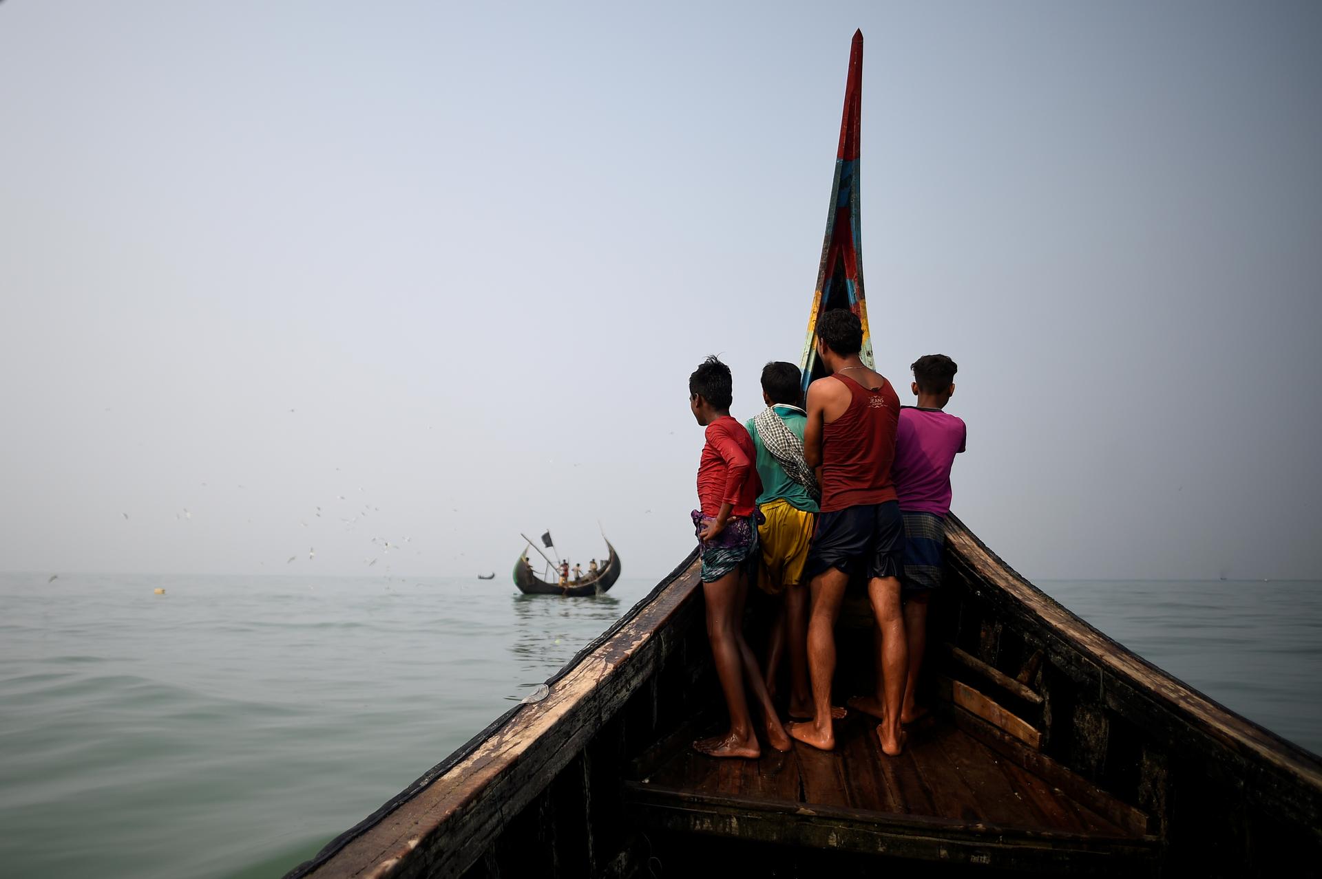 Rohingya refugees crew on a fishing boat