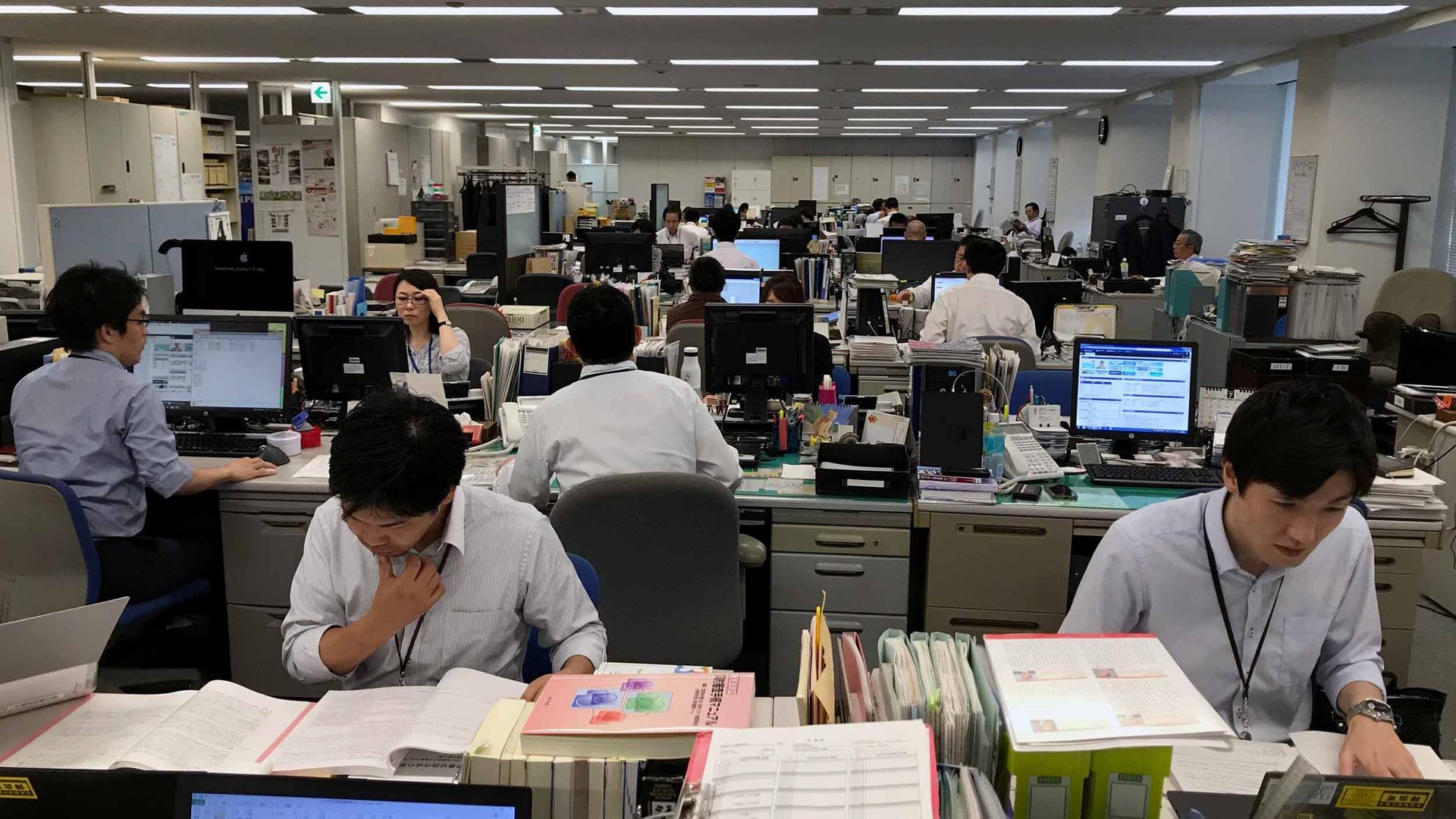People are working at computers in a large open office