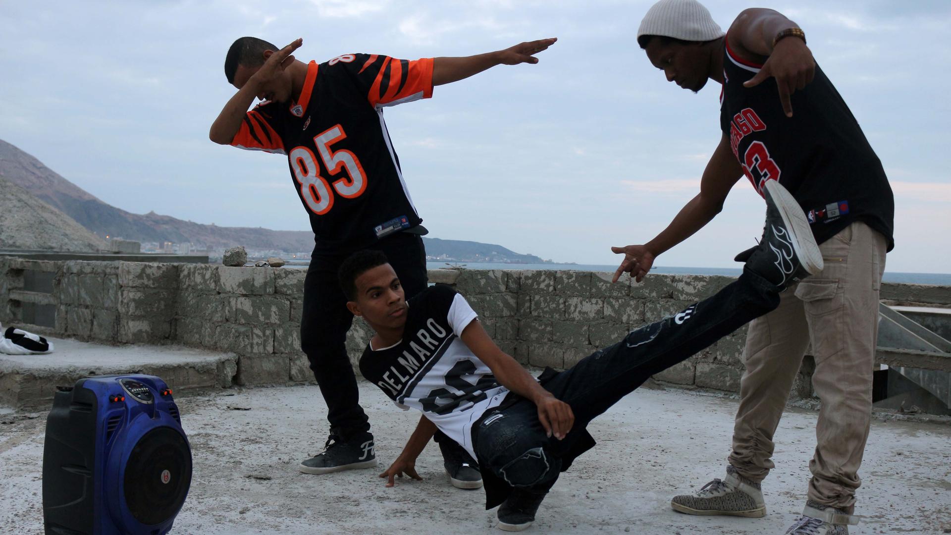 Three young men in hip-hop dance poses