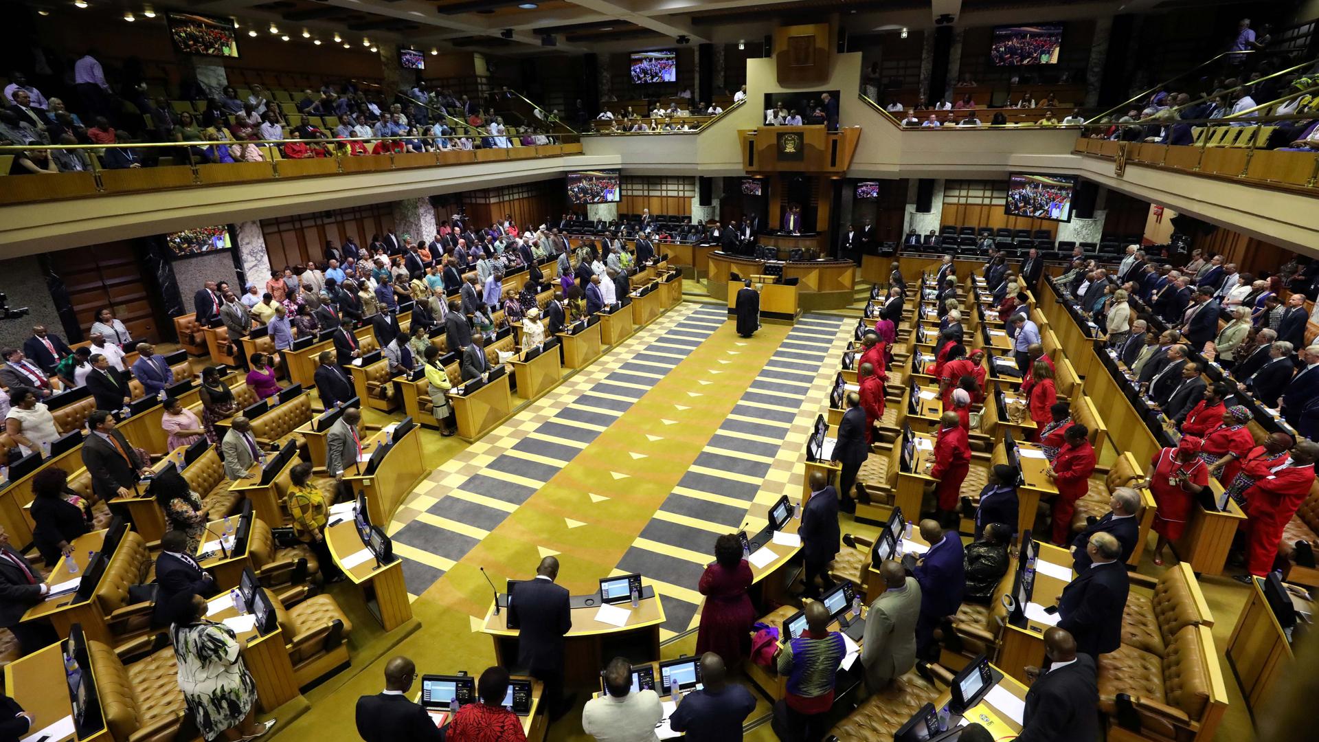 Members of parliament from a top-down view with a podium in the center