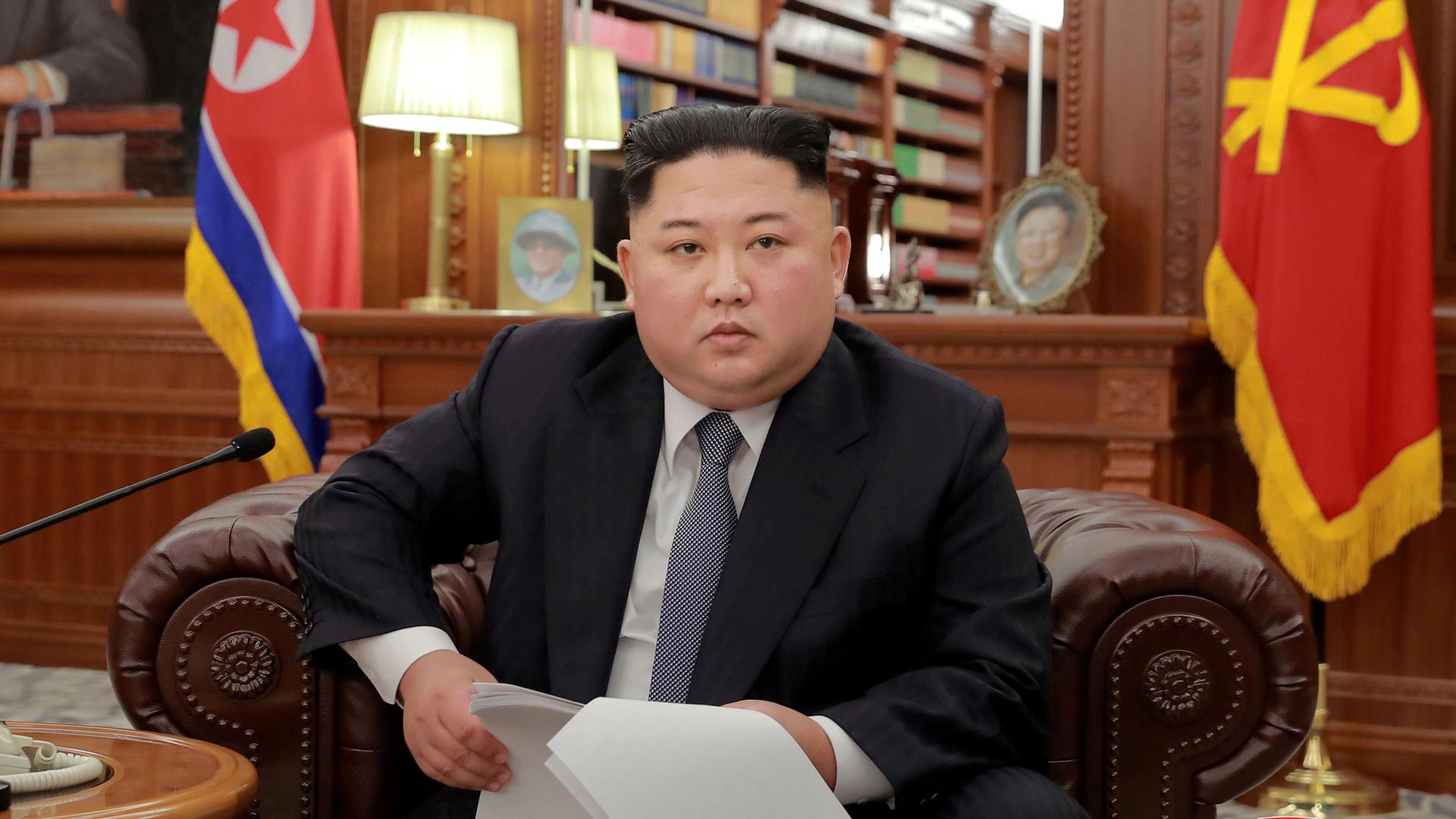 North Korean leader Kim Jong-un is shown in this file photo wearing a dark suit and sitting in a leather armchair.