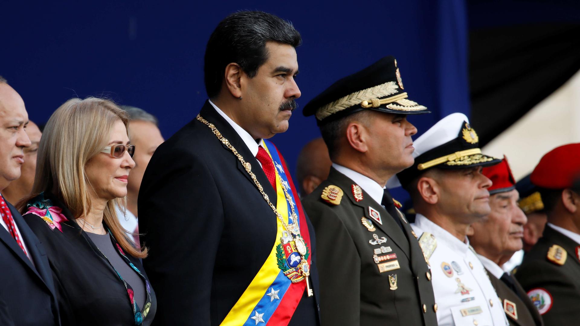 President Nicolas Maduro attends a ceremony in a suit and sash 