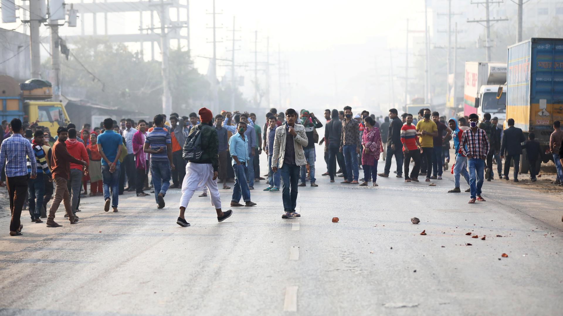 Garment workers block a road as they protest for higher wages. 