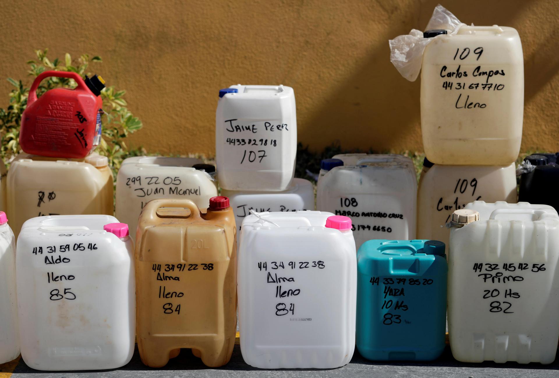 Empty containers are lined up at a gas station,