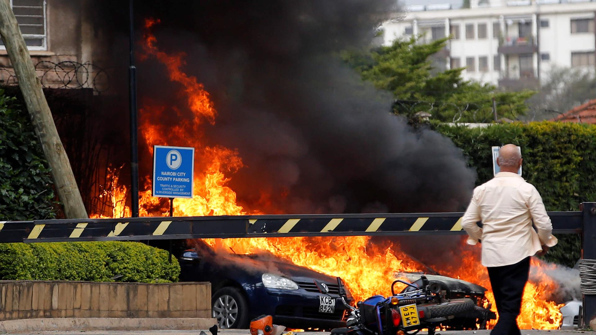 Car ablaze near hotel rocked by terrorist attack.
