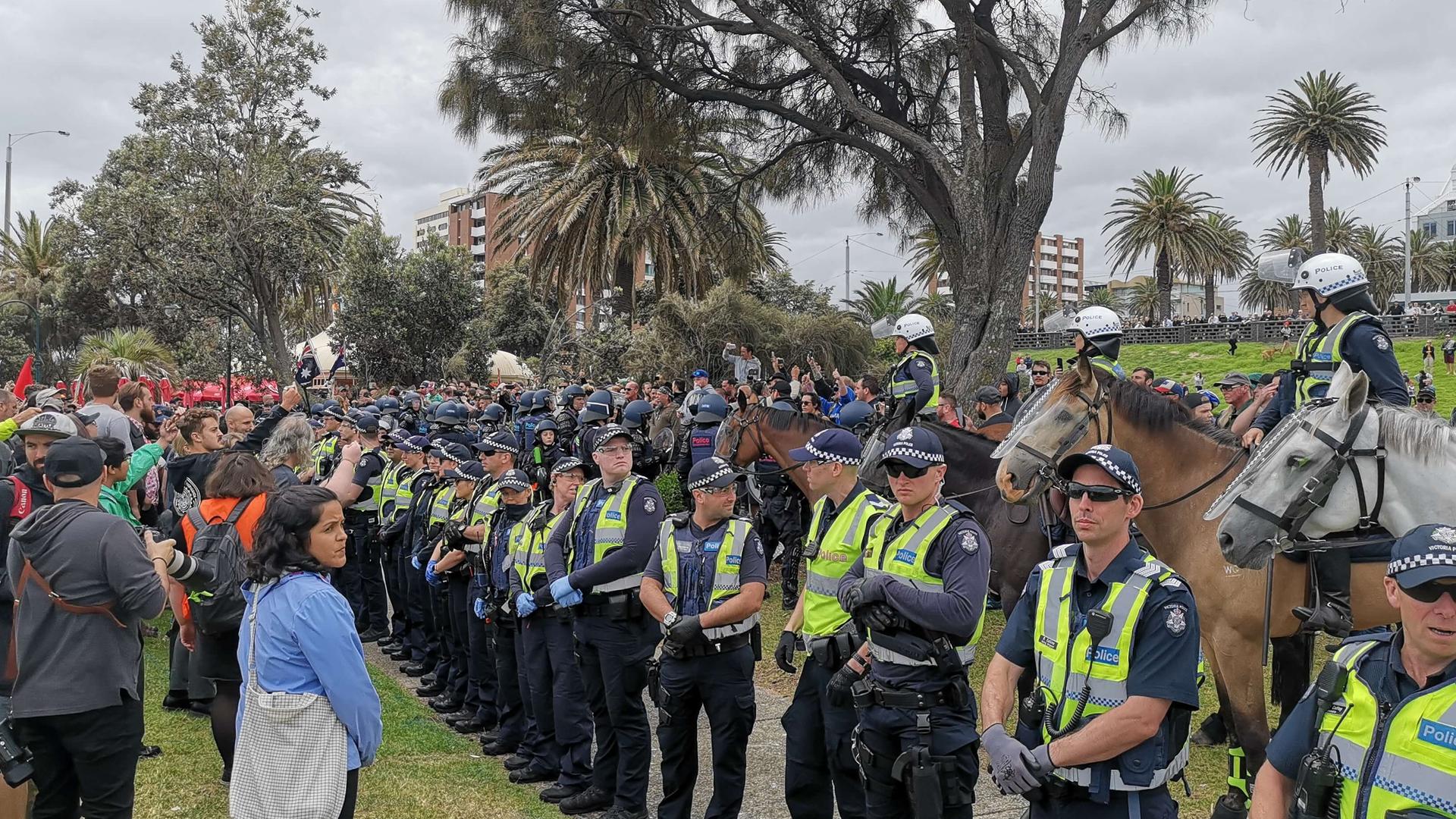 A line of protesters encounter a line of police.