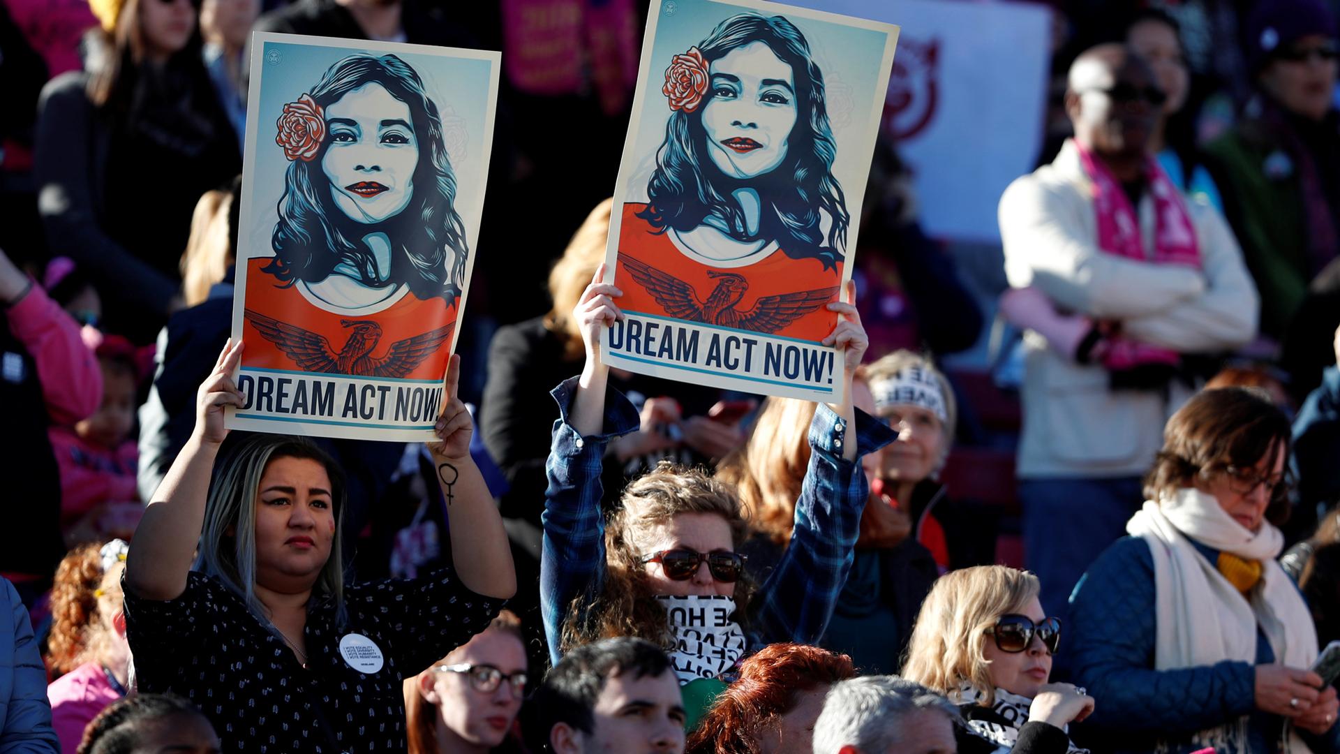 Supporters of Deferred Action for Childhood Arrivals (DACA) hold signs during the Women's March rally in Las Vegas, Jan. 21, 2018.