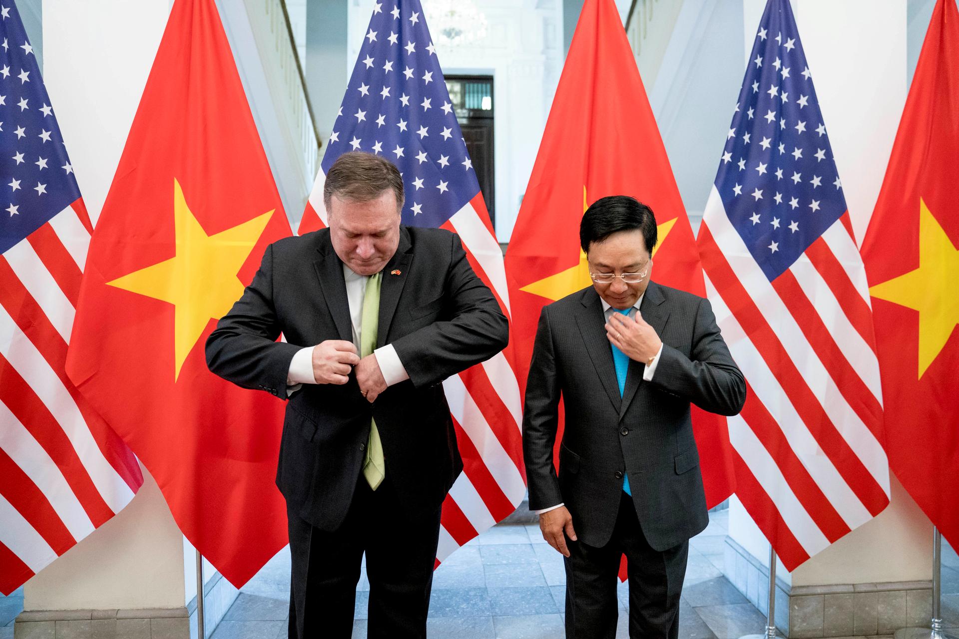 US Secretary of State Mike Pompeo and Vietnamese Deputy Prime Minister and Foreign Minister Pham Binh Minh arrive for a photo opportunity before a meeting at the Ministry of Foreign Affairs in Hanoi, Vietnam, July 9, 2018. 