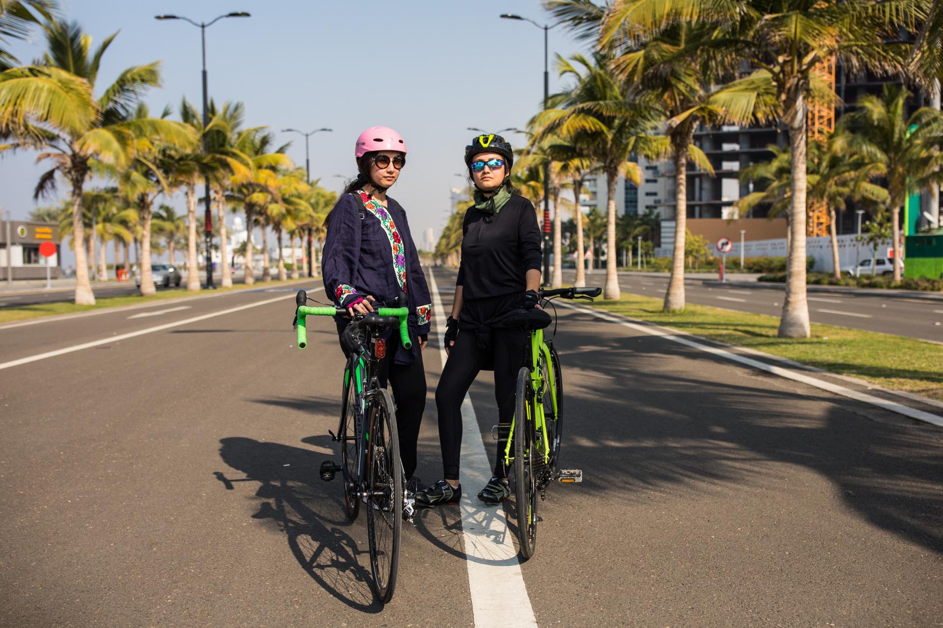 Doaa Naeem (right) and her sister Fatimah Naeem ride their bikes along the Corniche in Jeddah, Saudi Arabia.