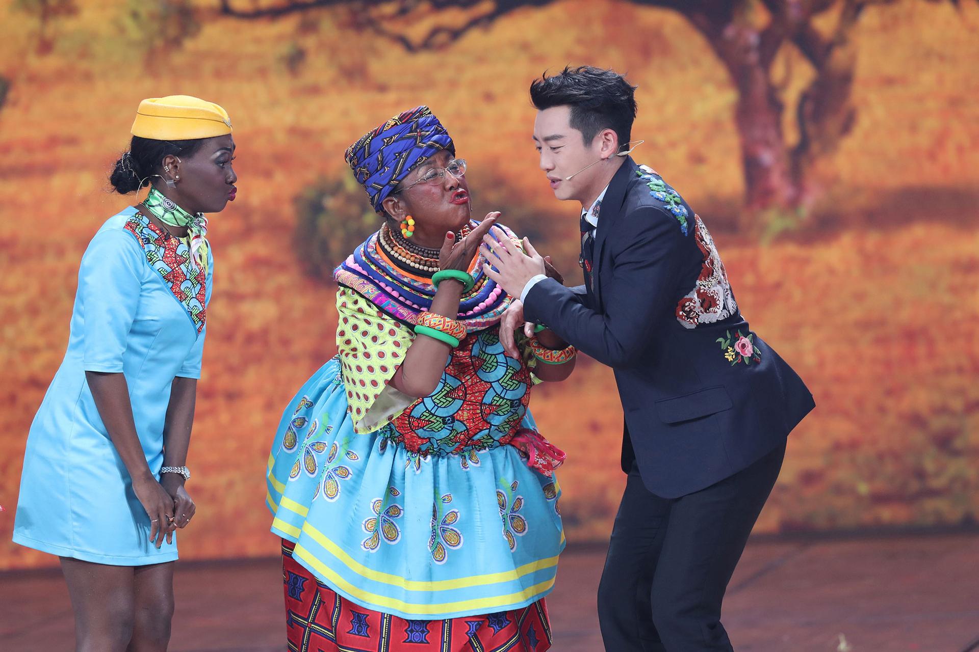 Chinese actor Lou Naiming is shown performs a skit wearing blackface and a colorful dress.