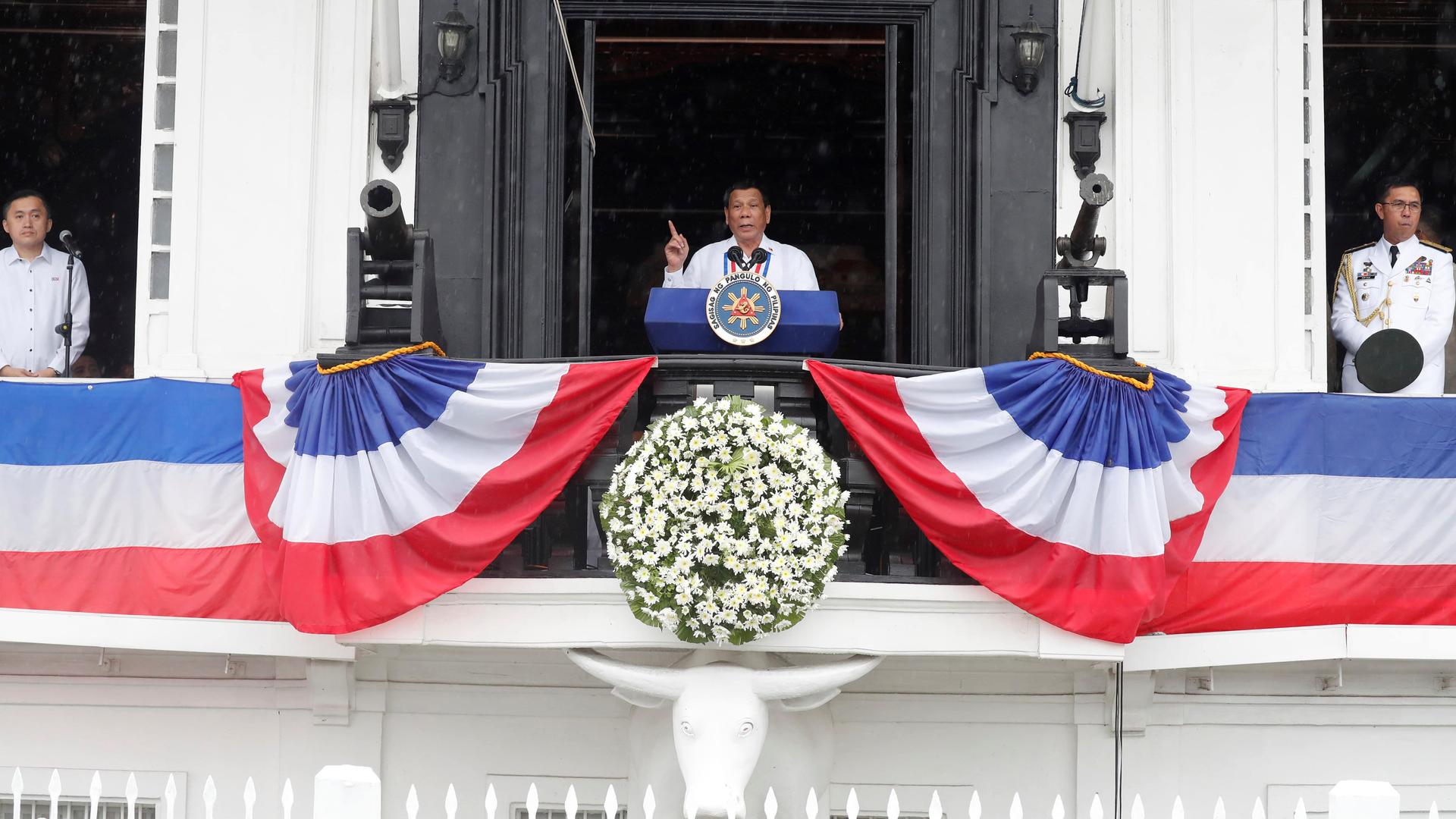 Philippine's President Rodrigo Duterte speaks from a balcony 