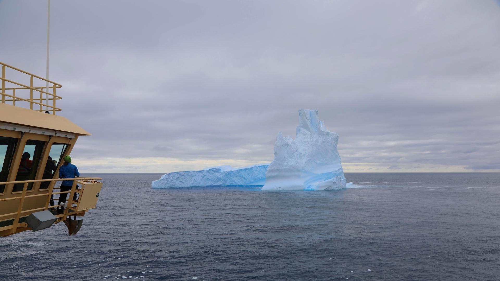 Researchers aboard the Nathanial B. Palmer gather on the ship’s bridge to view one of the first icebergs they encountered. 