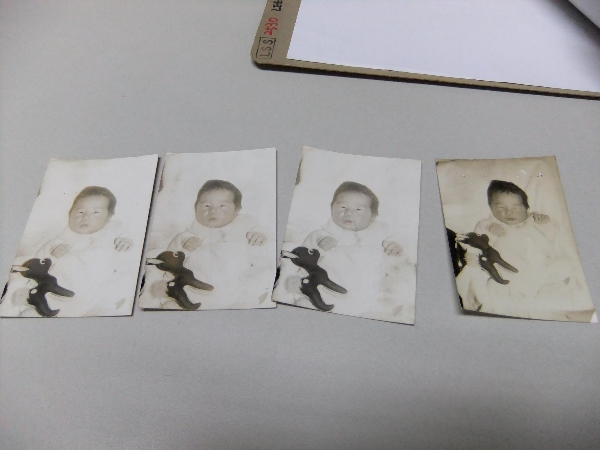 Four black and white photos of a Korean baby in a row, with a file folder above. 
