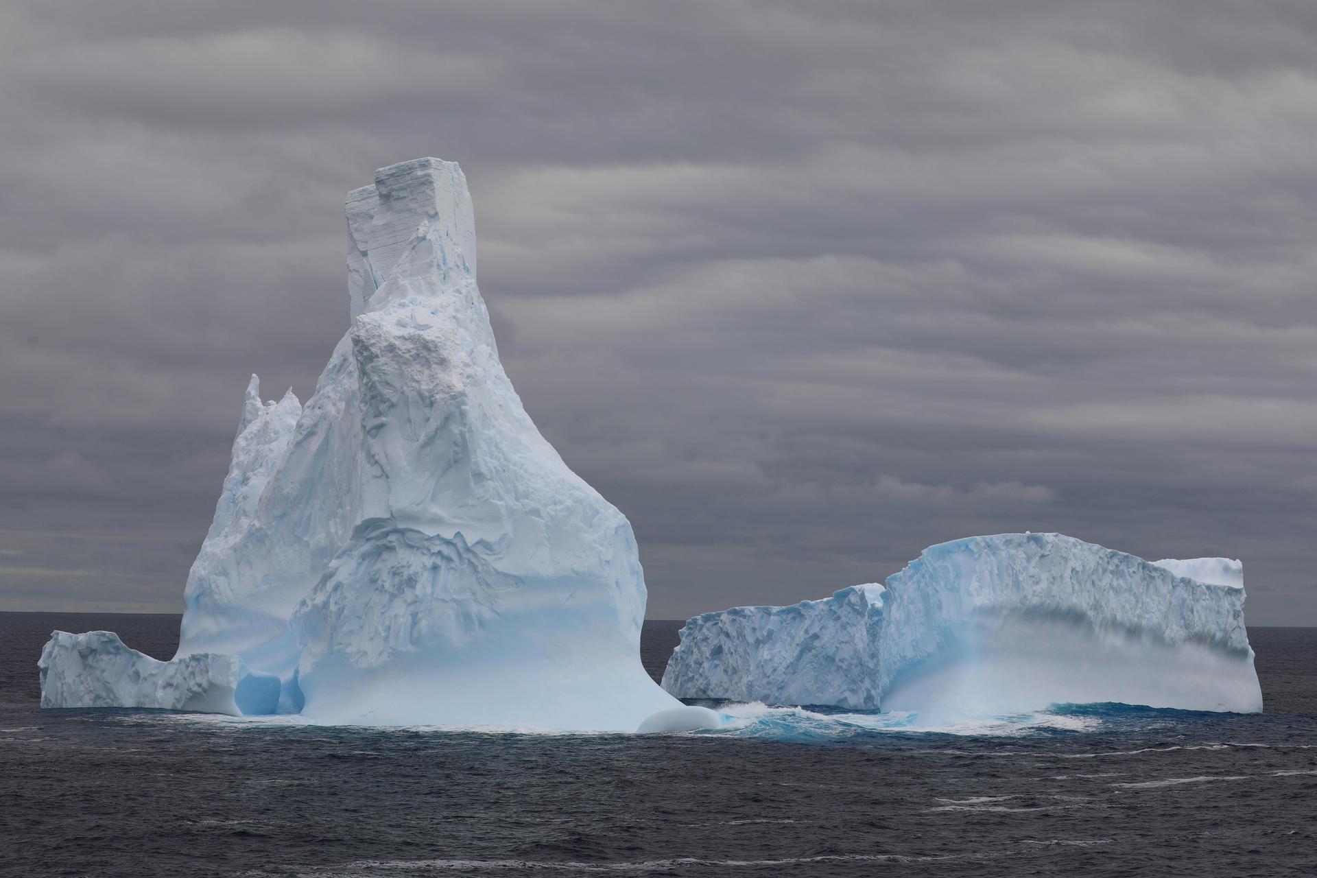 Tall white iceberg recedes to the stern of the Nathaniel B. Palmer.