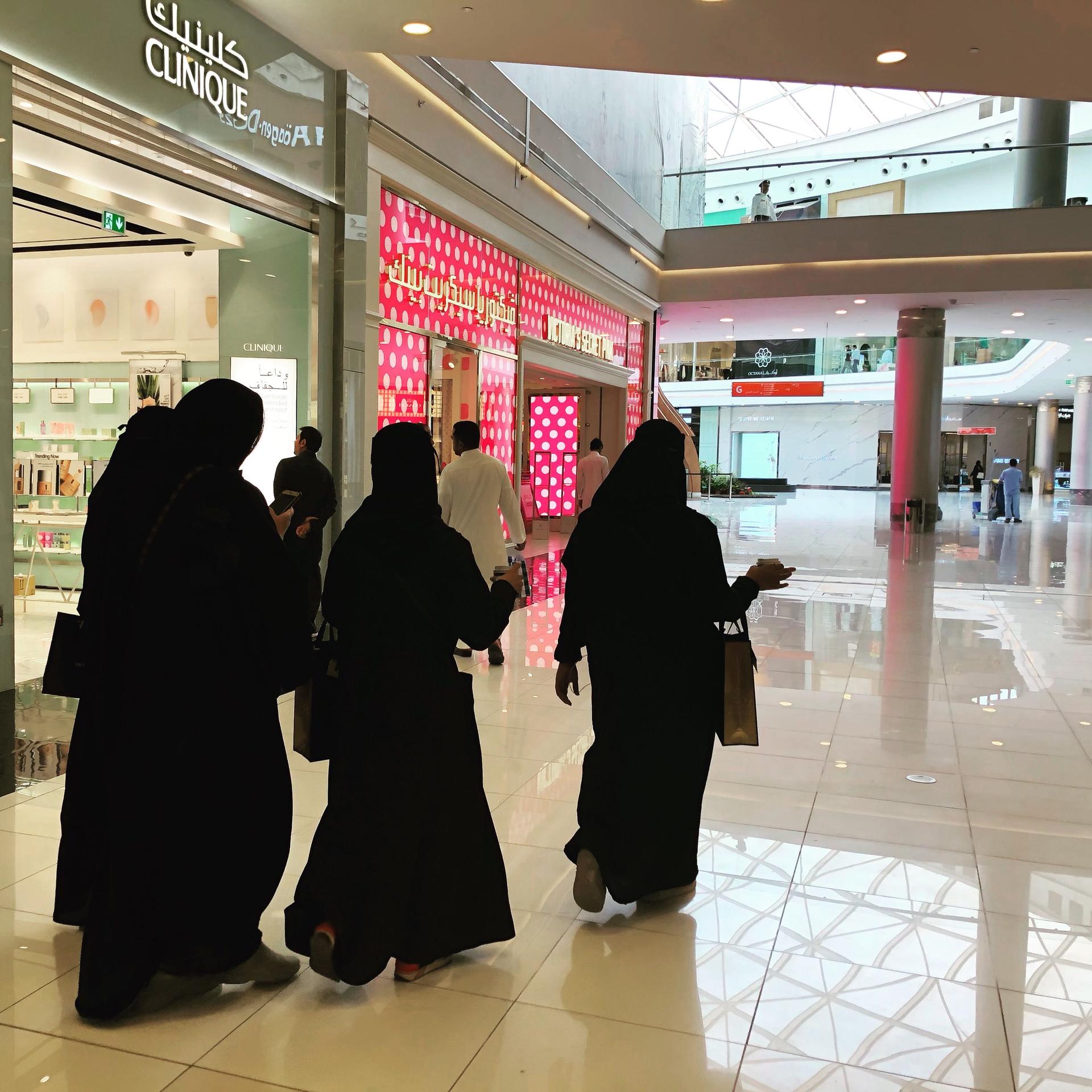 Women wearing black abaya at a mall in Saudi Arabia.