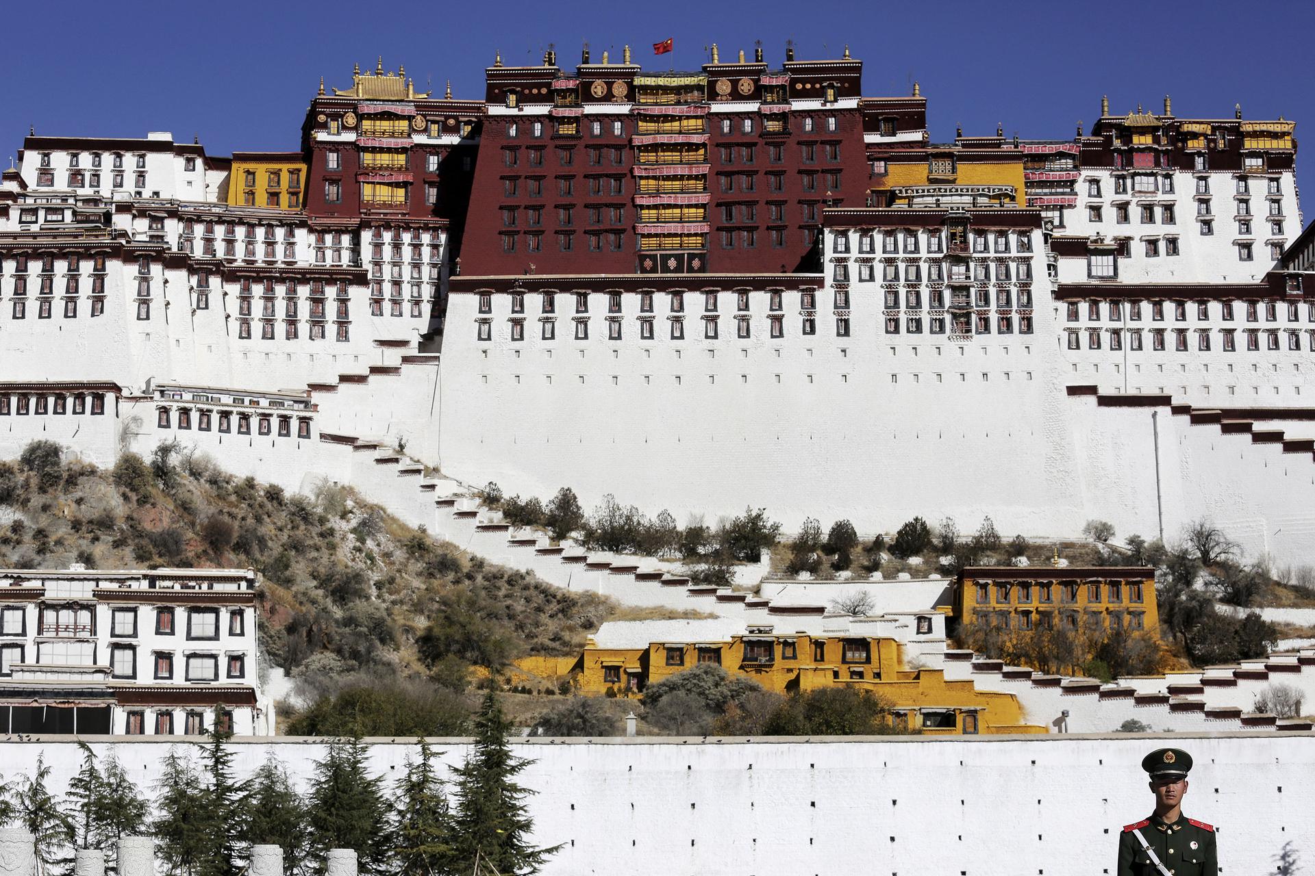 A Chinese guard stands in front of the Potala Palace