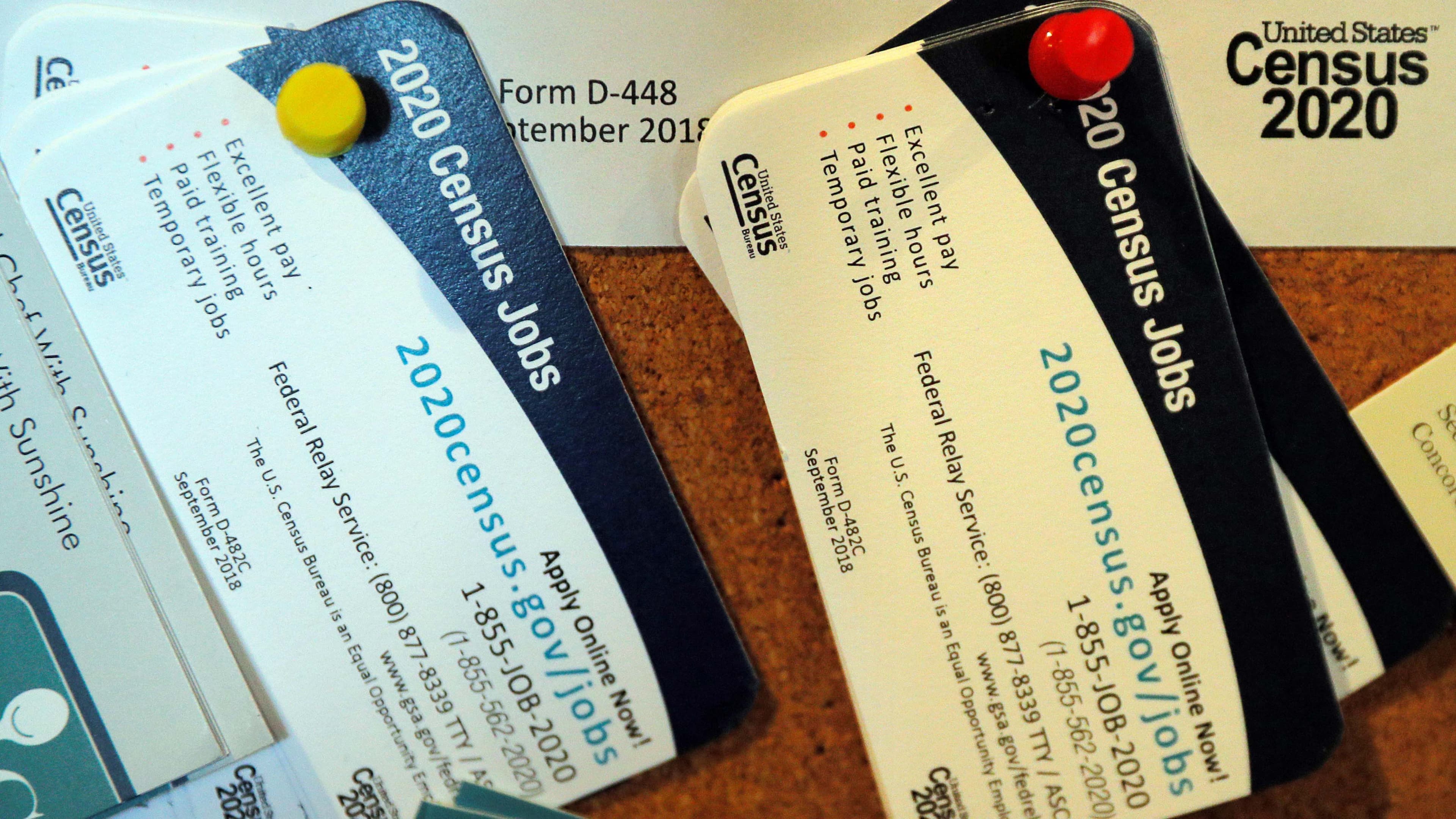 Business-card advertisements for census 2020 jobs are pinned to a bulletin board