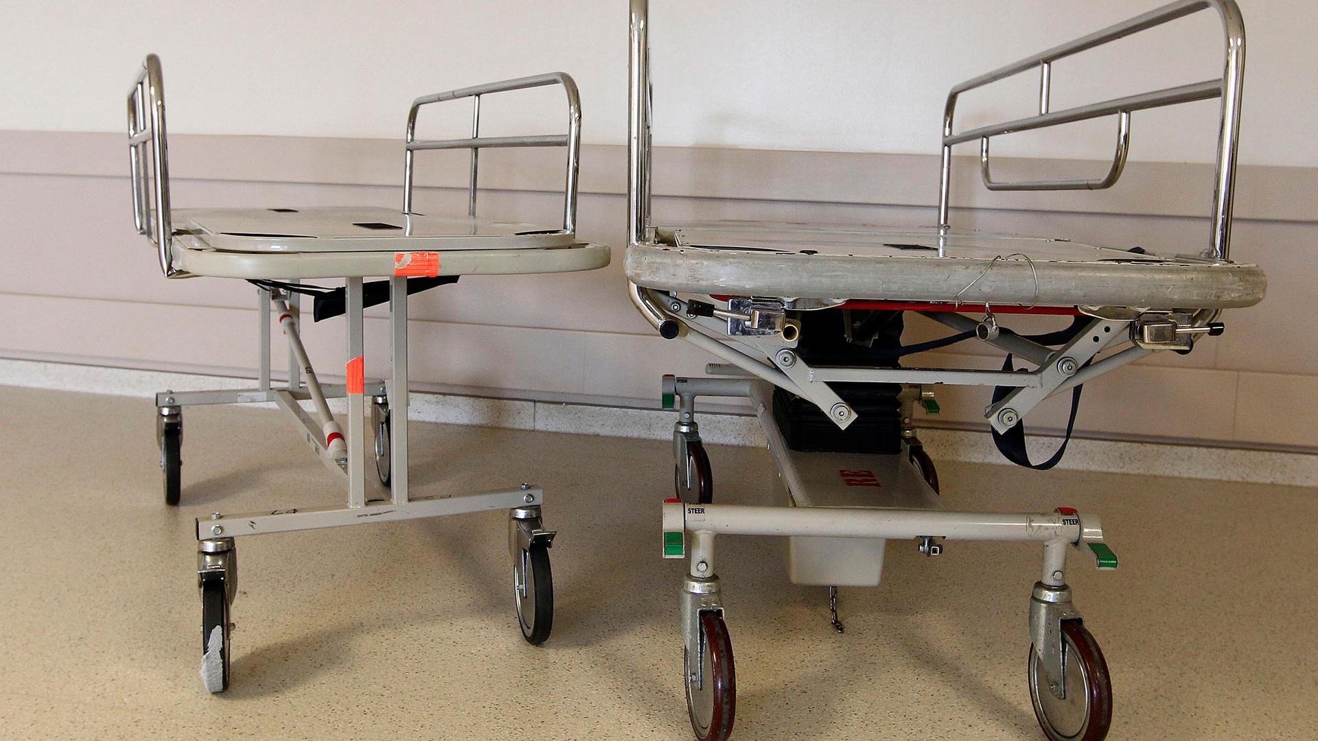 A smaller metal gurney is shown next to a larger one in the hallway of a maternity ward at the University of Alabama Hospital.