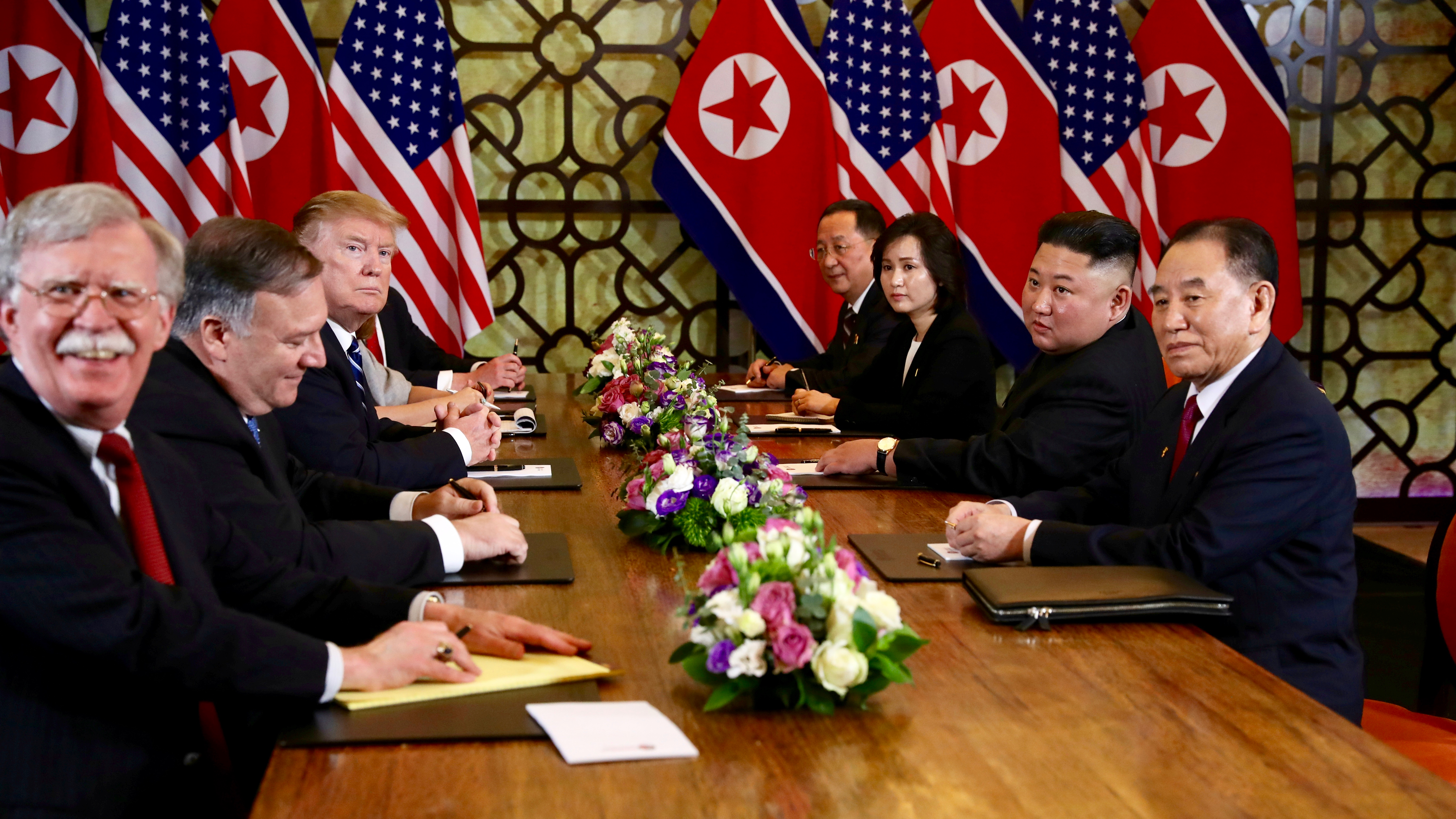 US President Donald Trump and North Korea's leader Kim Jong-un look on while White House national security adviser John Bolton reacts during the extended bilateral meeting in the Metropole Hotel alongside US Secretary of State Mike Pompeo, North Korean Fo