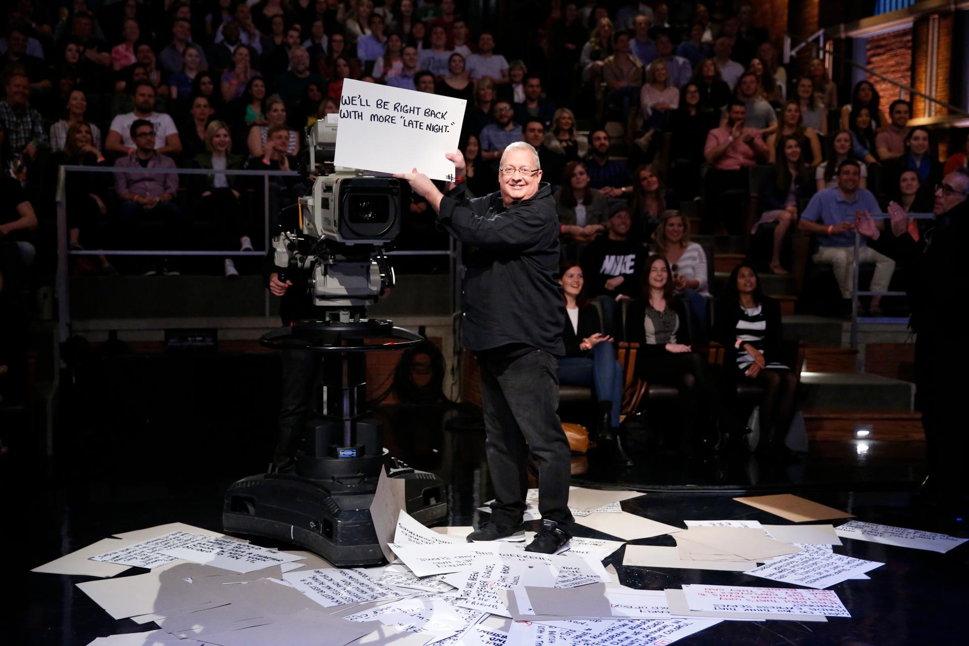 Cue-card guy, Wally Feresten during a "Late Night" sketch on May 11, 2016.