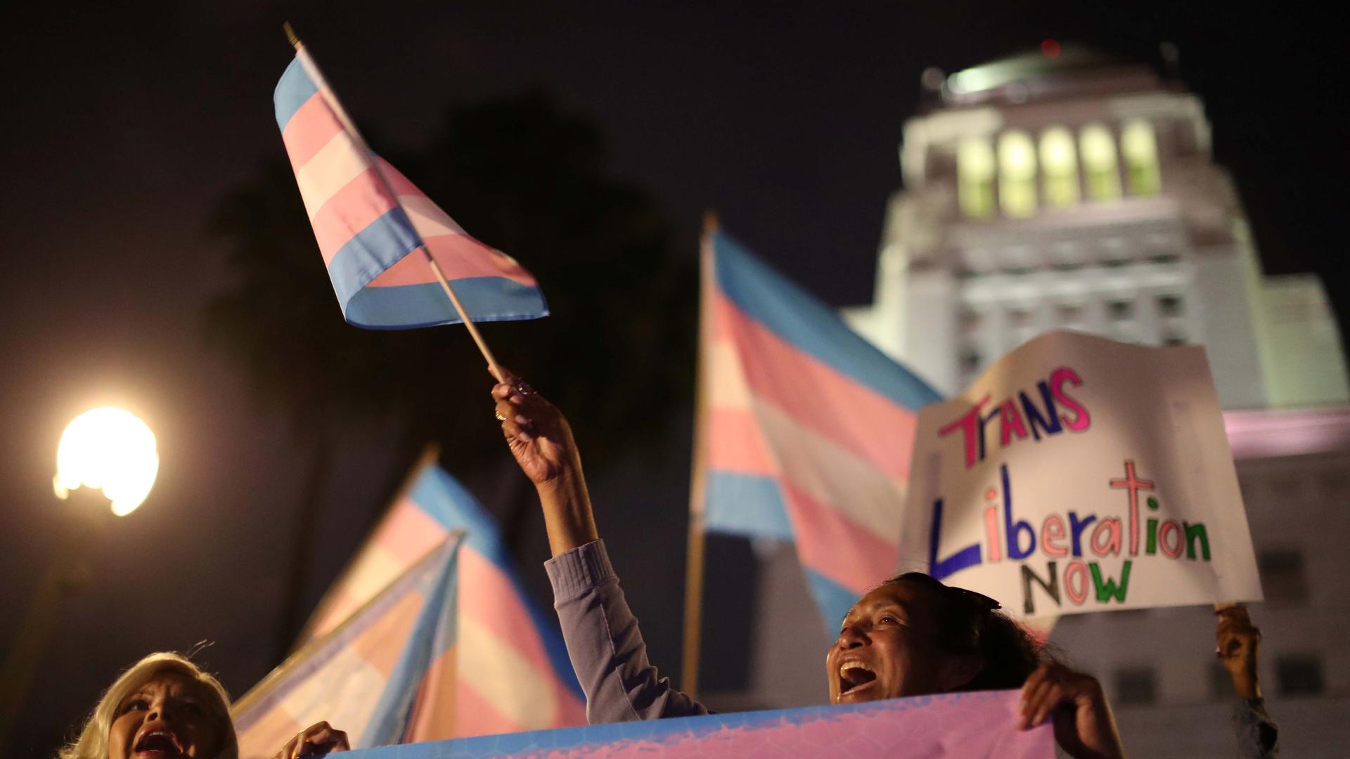 Women protest with transgender flags