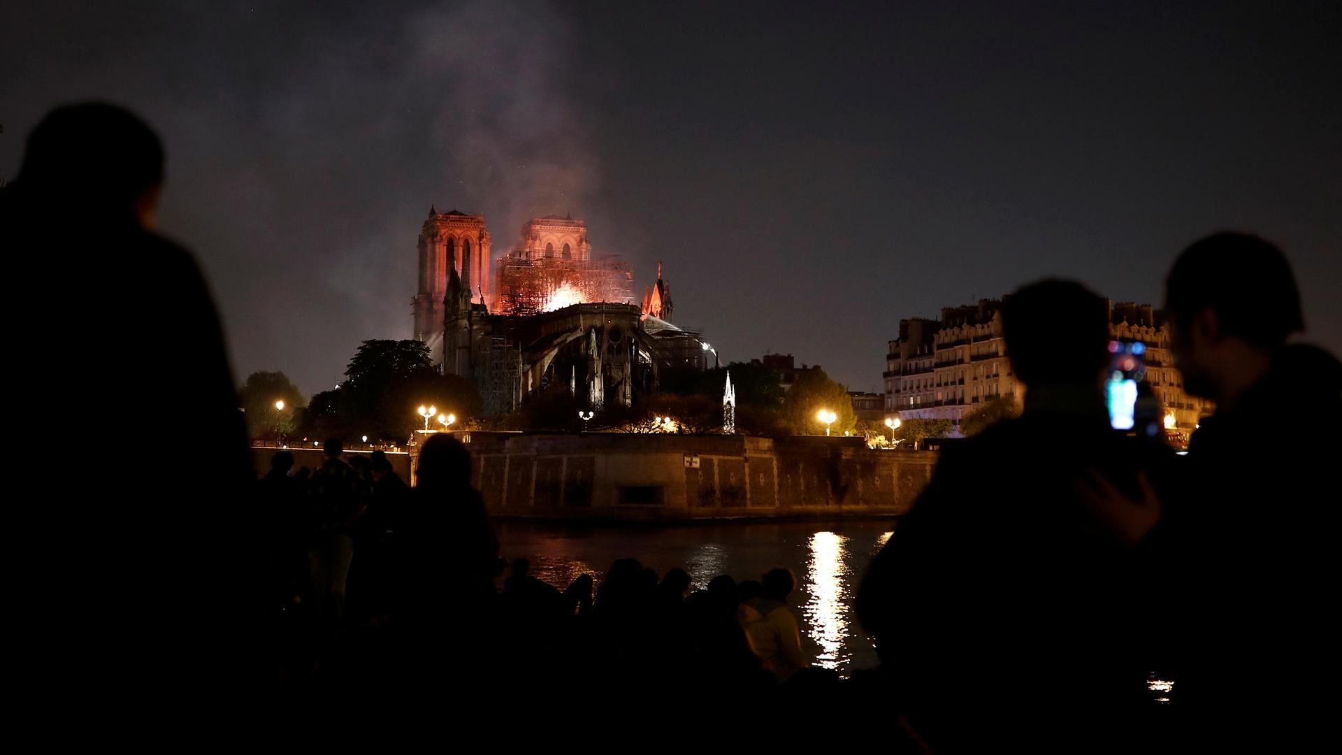 in the distance, the Notre Dame burns