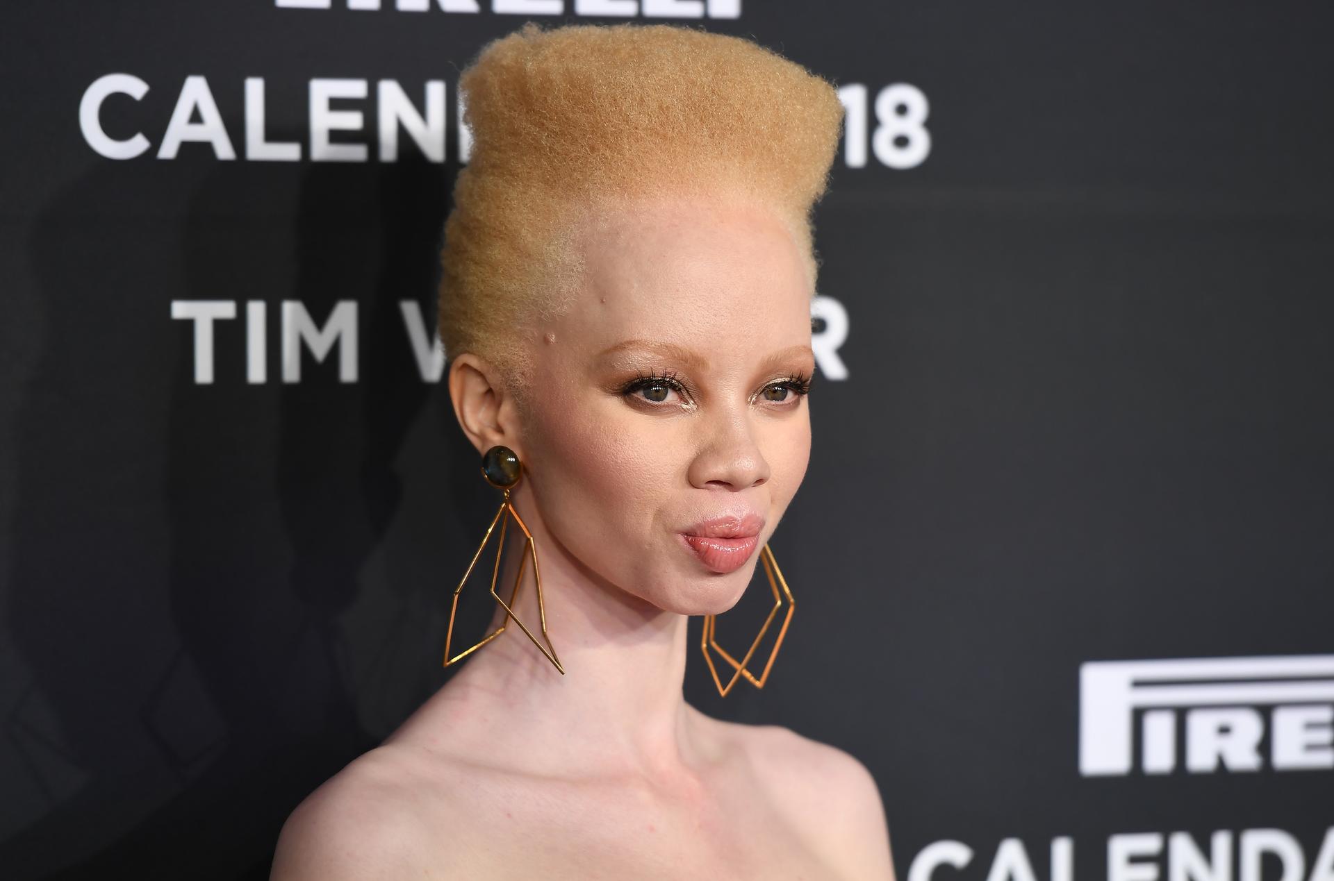 Thando Hopa stands on a red carpet.