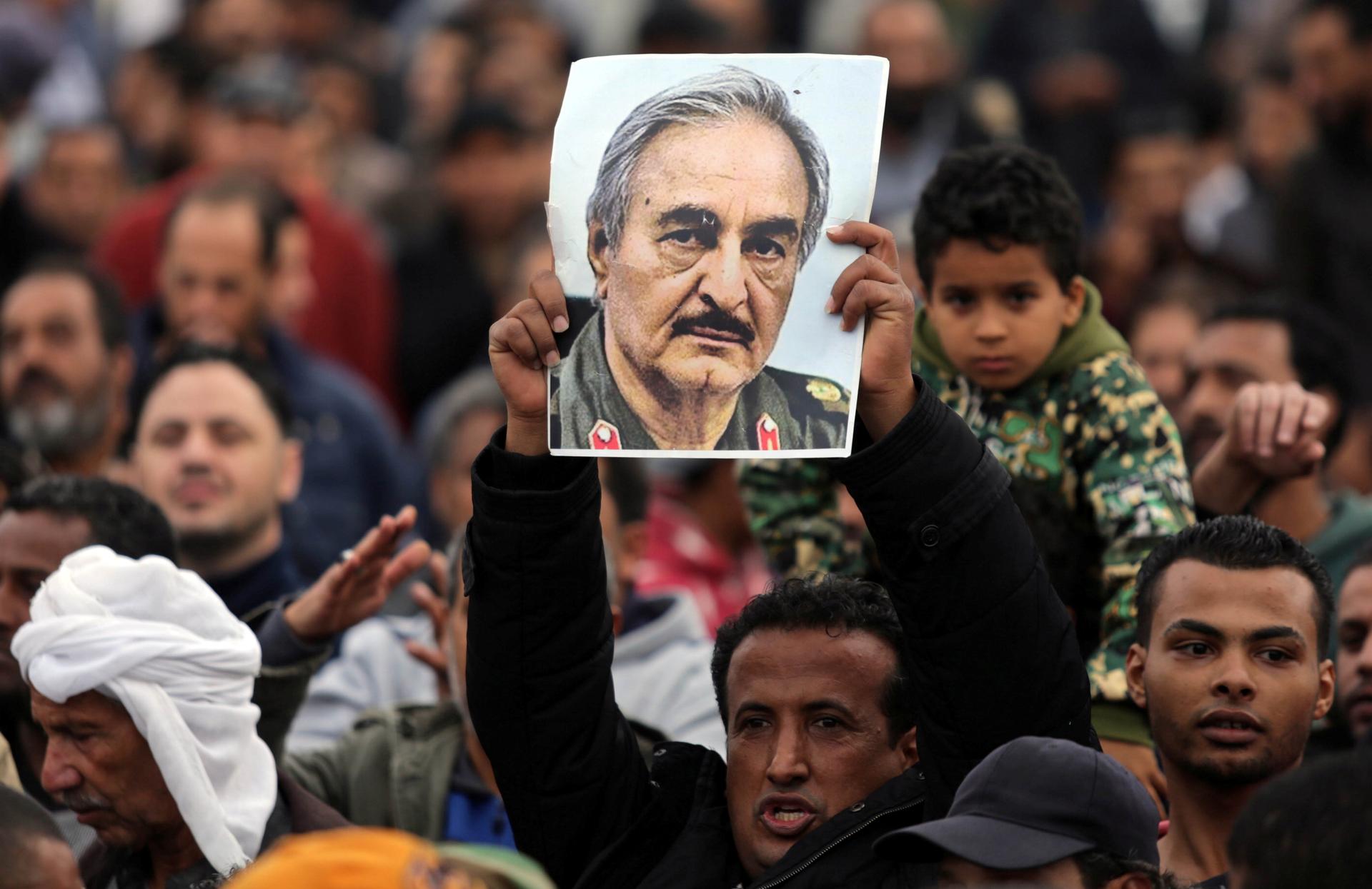 A man holds a poster of eastern Libyan military commander Khalifa Haftar 