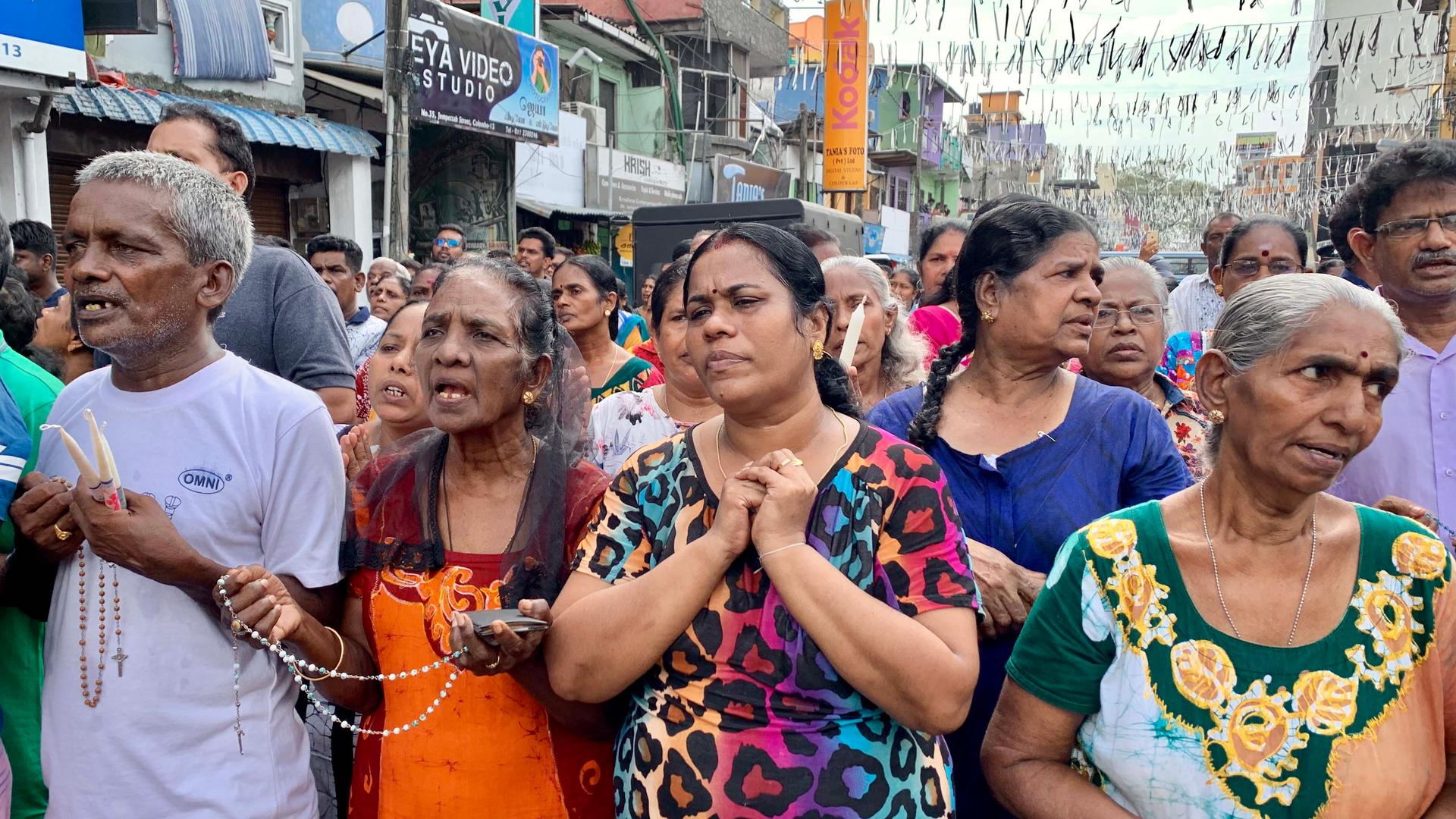 Crowds holding candles and rosaries pray in the week following the Easter Sunday suicide bombings in Sri Lanka. 