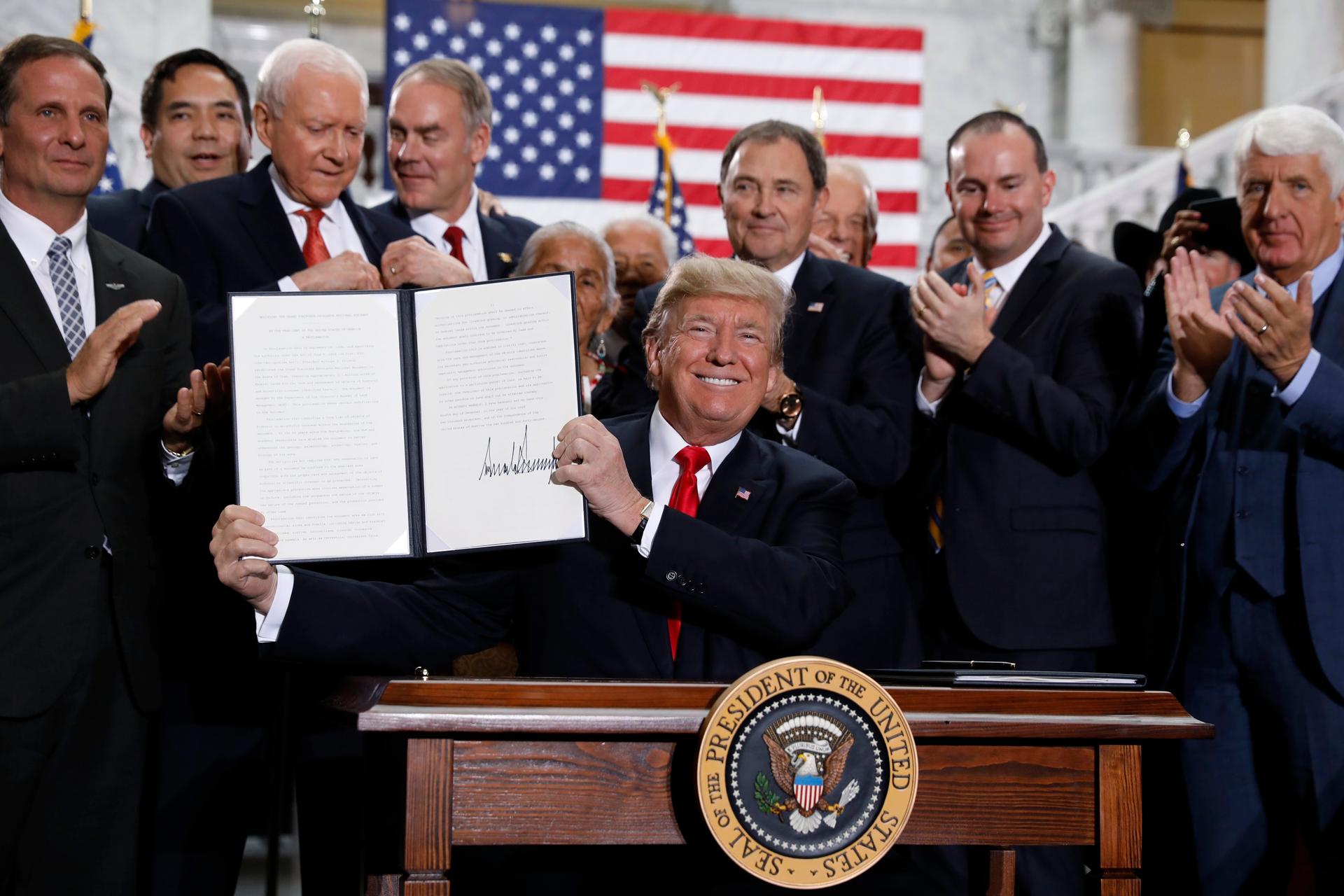US President Donald Trump displays an executive order