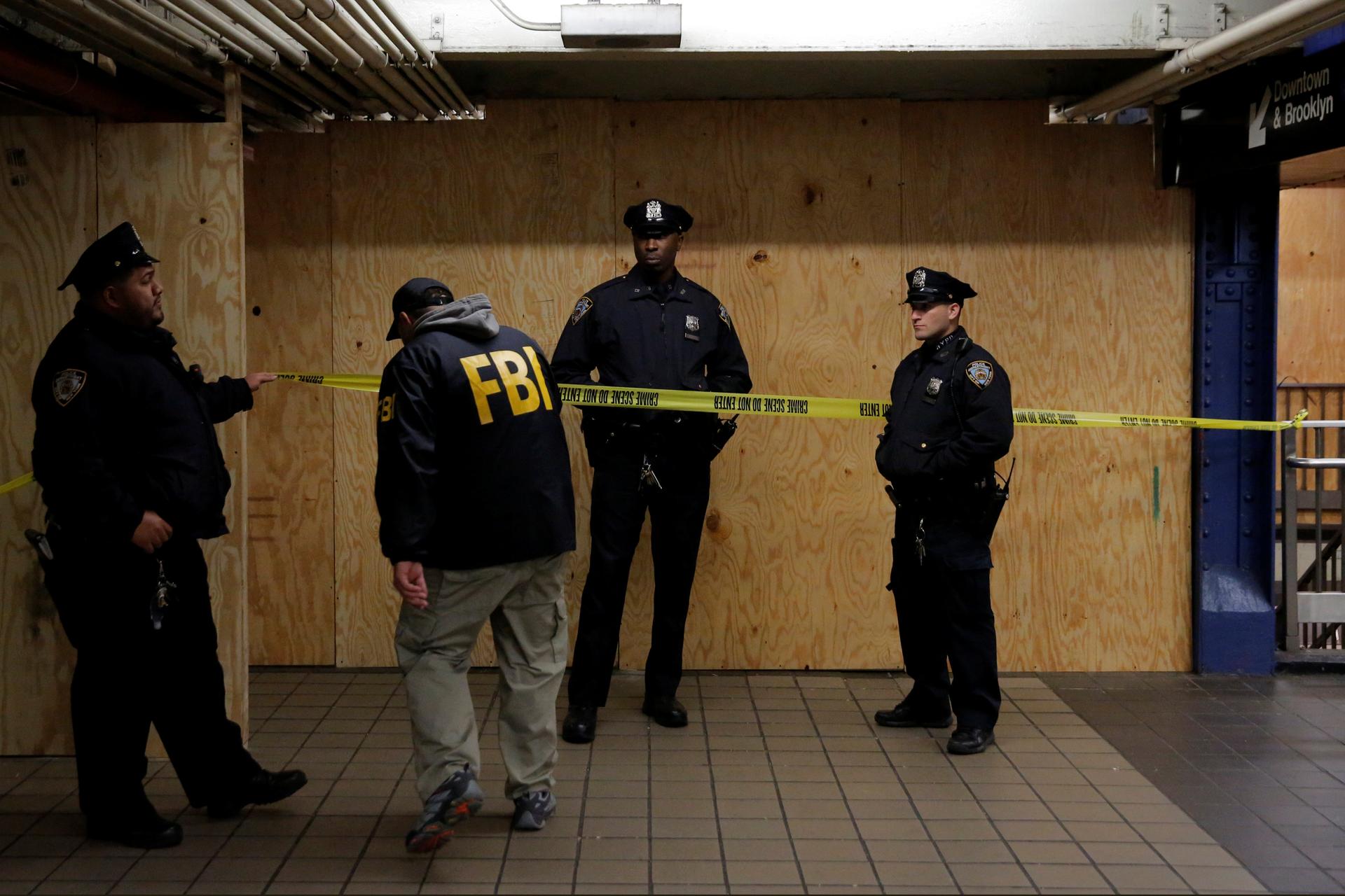 A member of the FBI enters the crime scene beneath the New York Port Authority Bus Terminal following an attempted bombing during the morning rush hour.