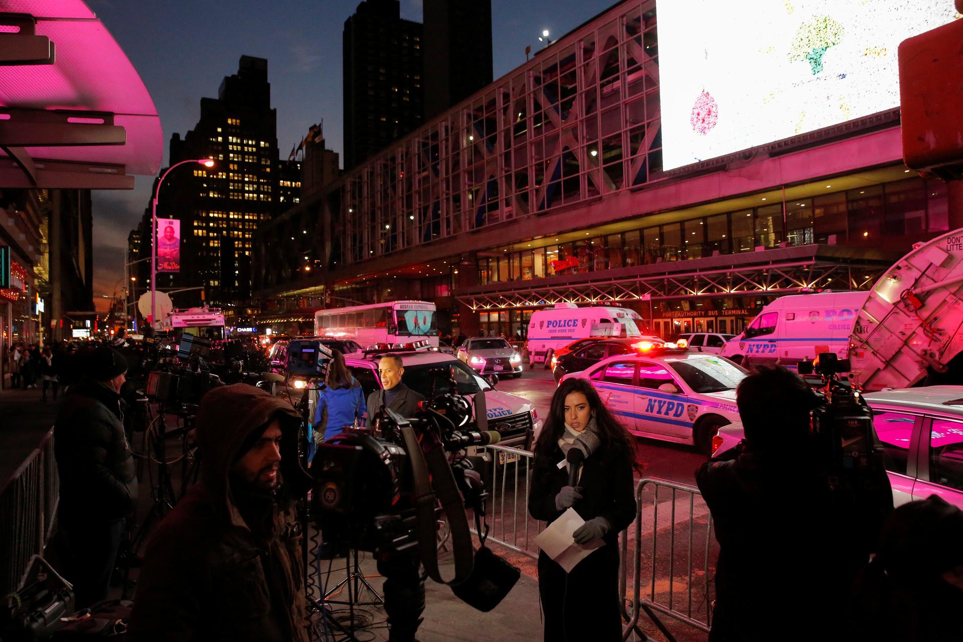 Members of the media gather by the New York Port Authority bus terminal following an attempted bombing.