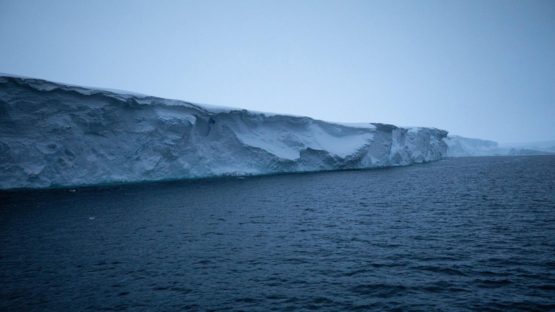 The eastern ice tongue of Thwaites Glacier is shown rising out of deep blue ocean waters.