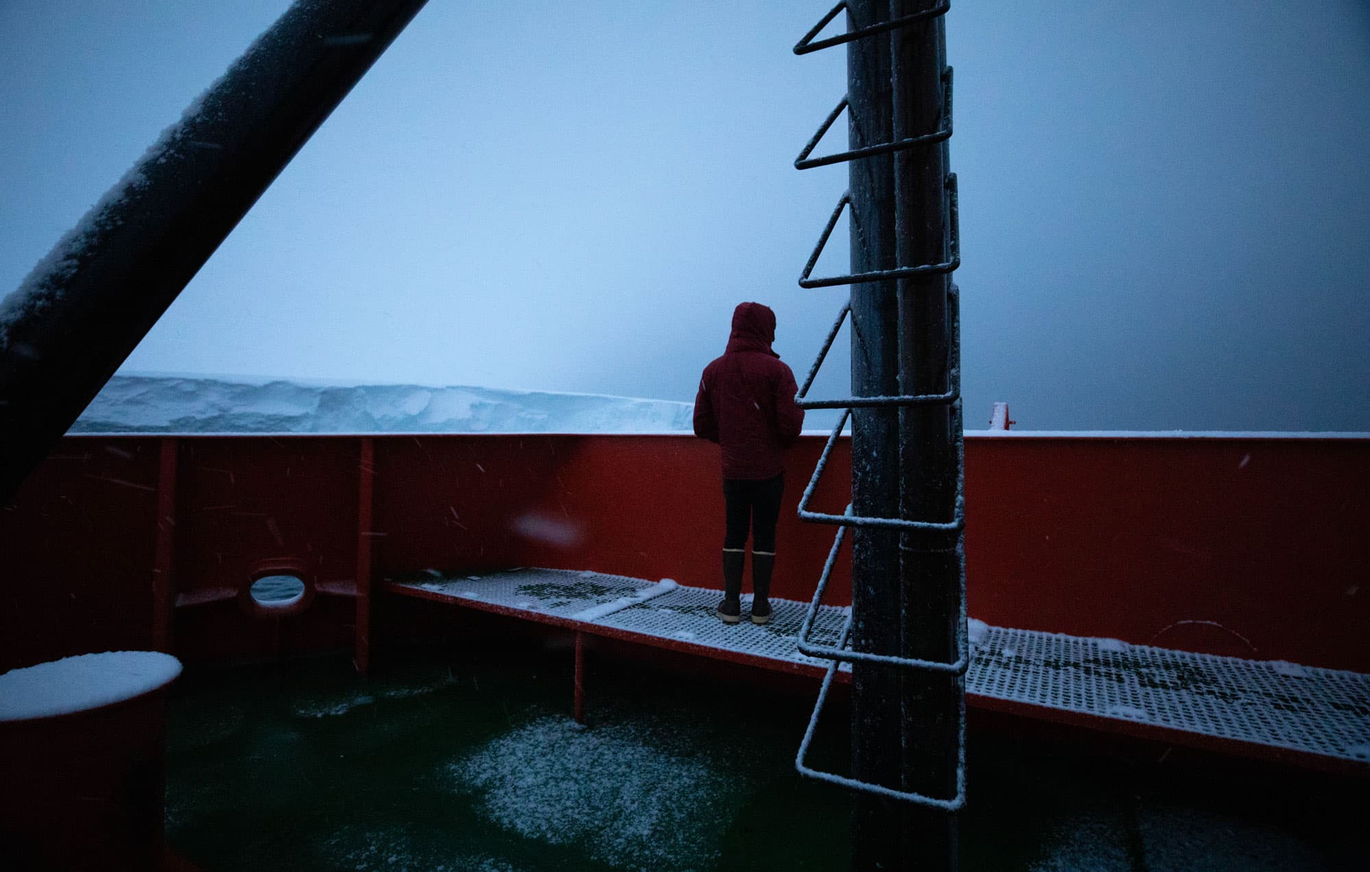 Oceanographer Peter Sheehan is shown with his jacket hood over his head while looking out at Thwaites.