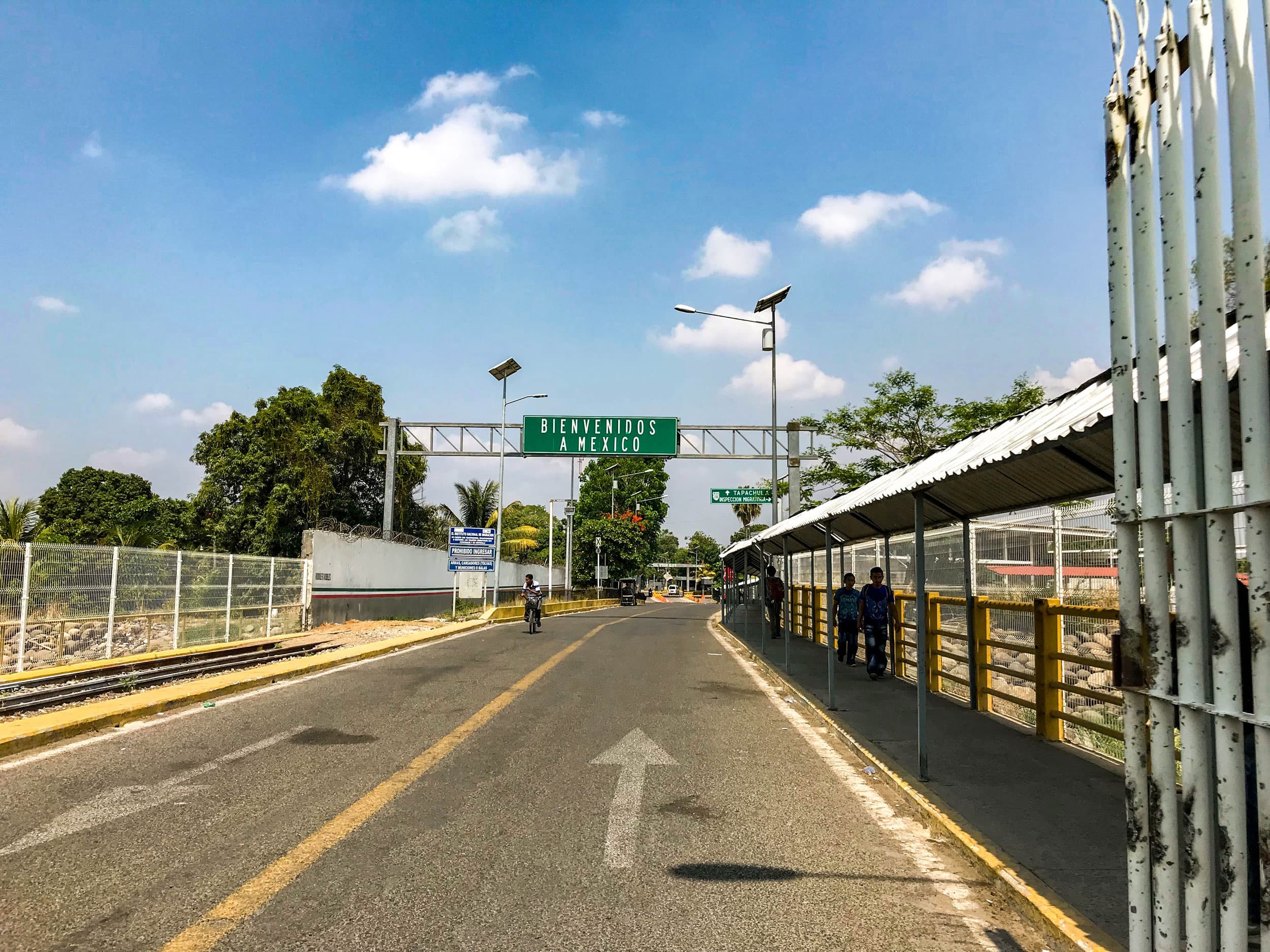 An official entry point from Guatemala into Mexico with a large green sign that reads,
