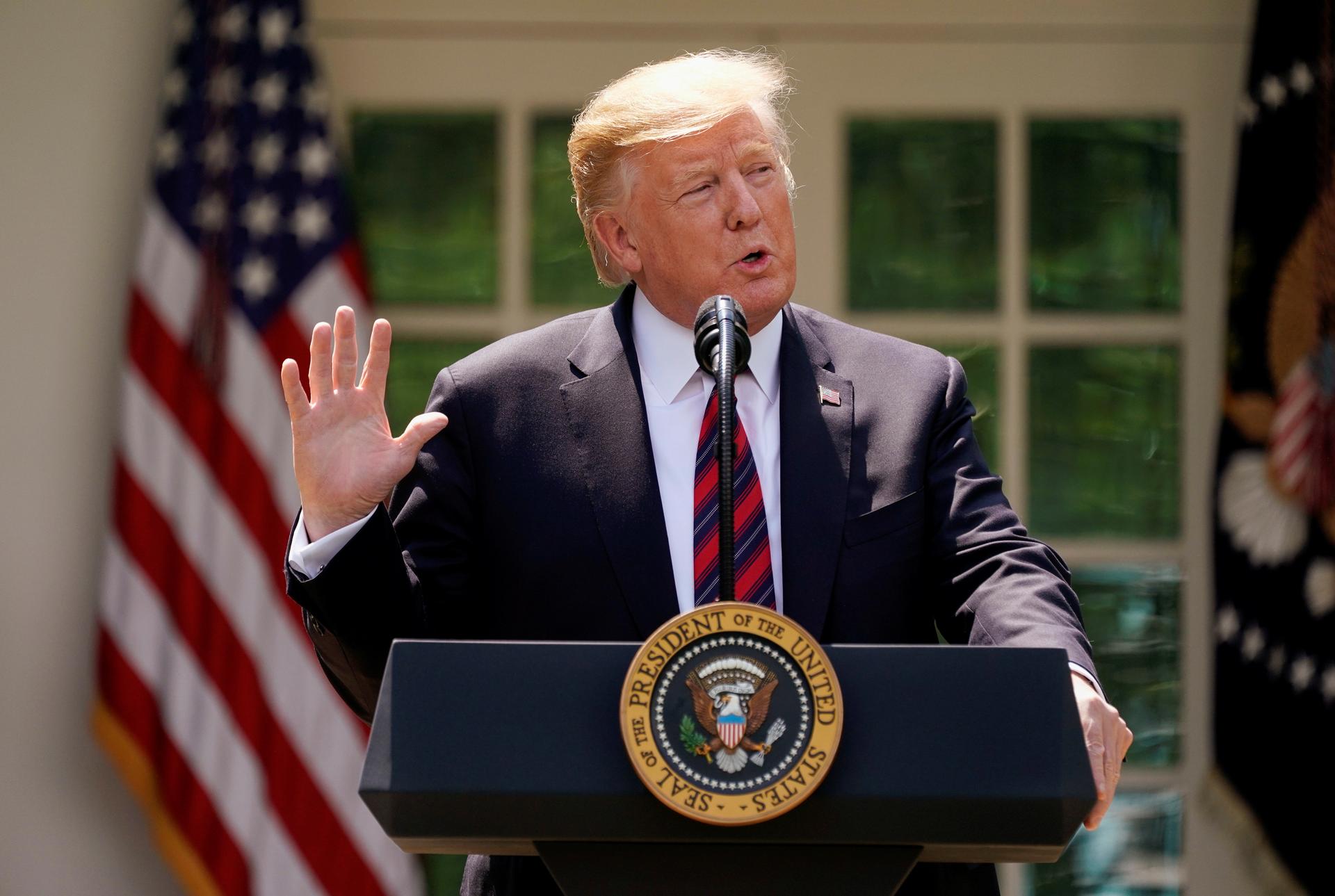 US President Donald Trump delivers remarks on immigration reform at a podium in the Rose Garden of the White House in Washington, DC, May 16, 2019
