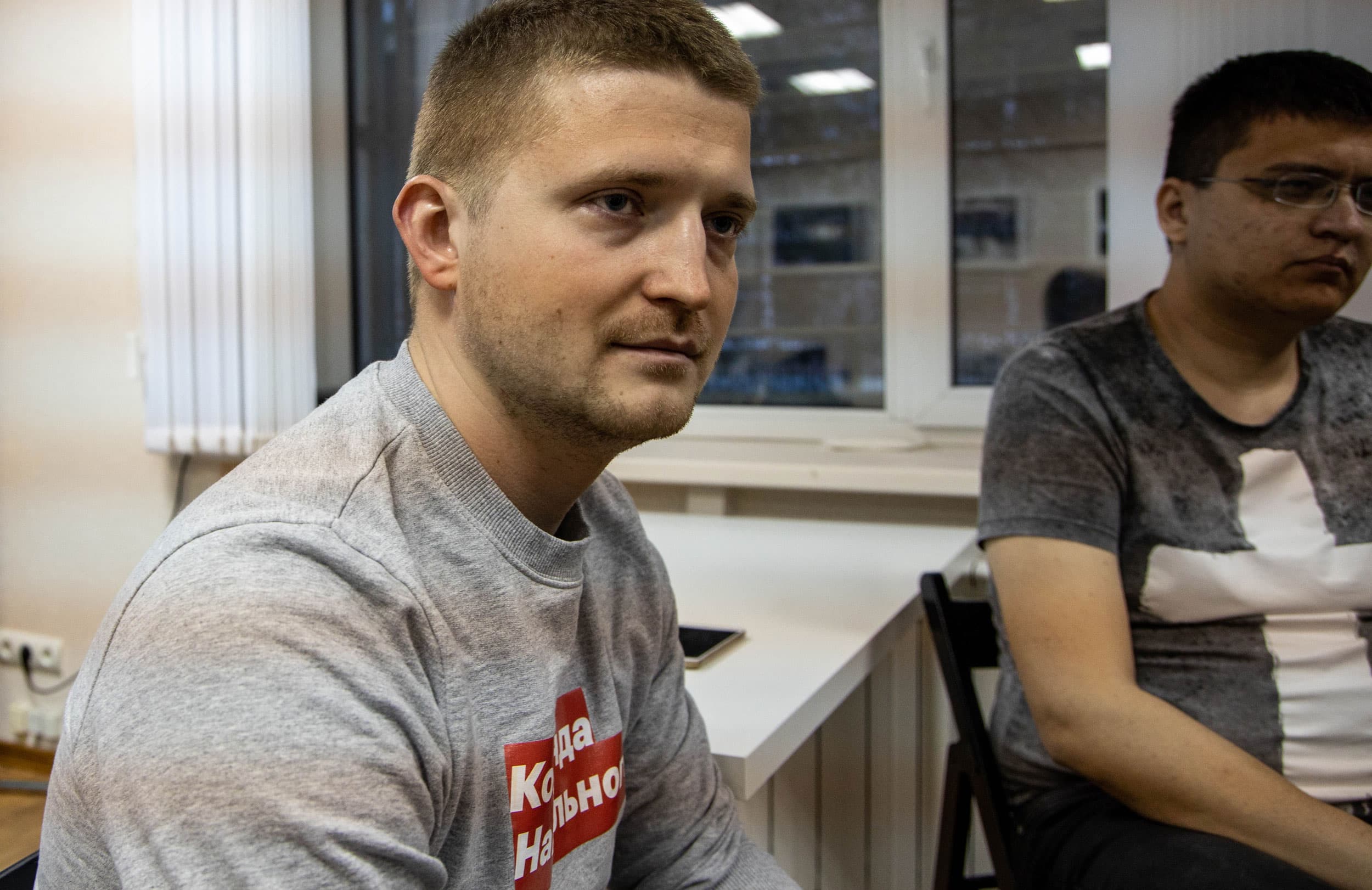 Dimitry Silivonchik is shown wearing a grey sweathshirt.
