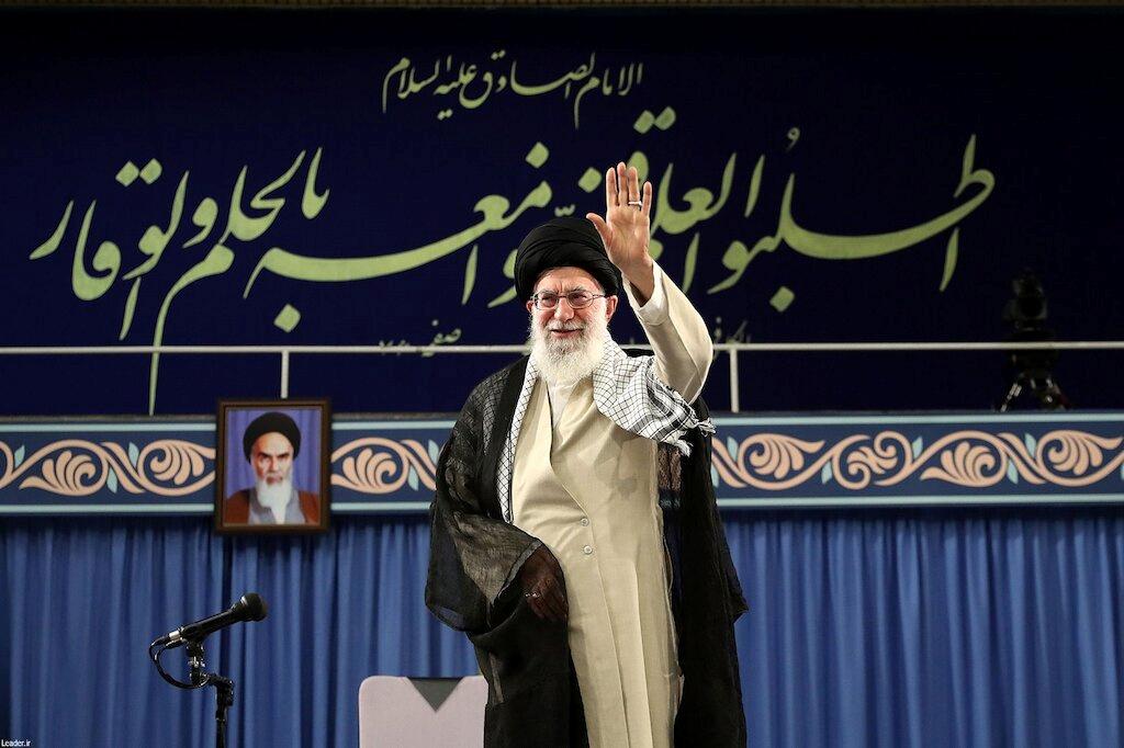 Ayatollah Khamenei stands on a stage. 