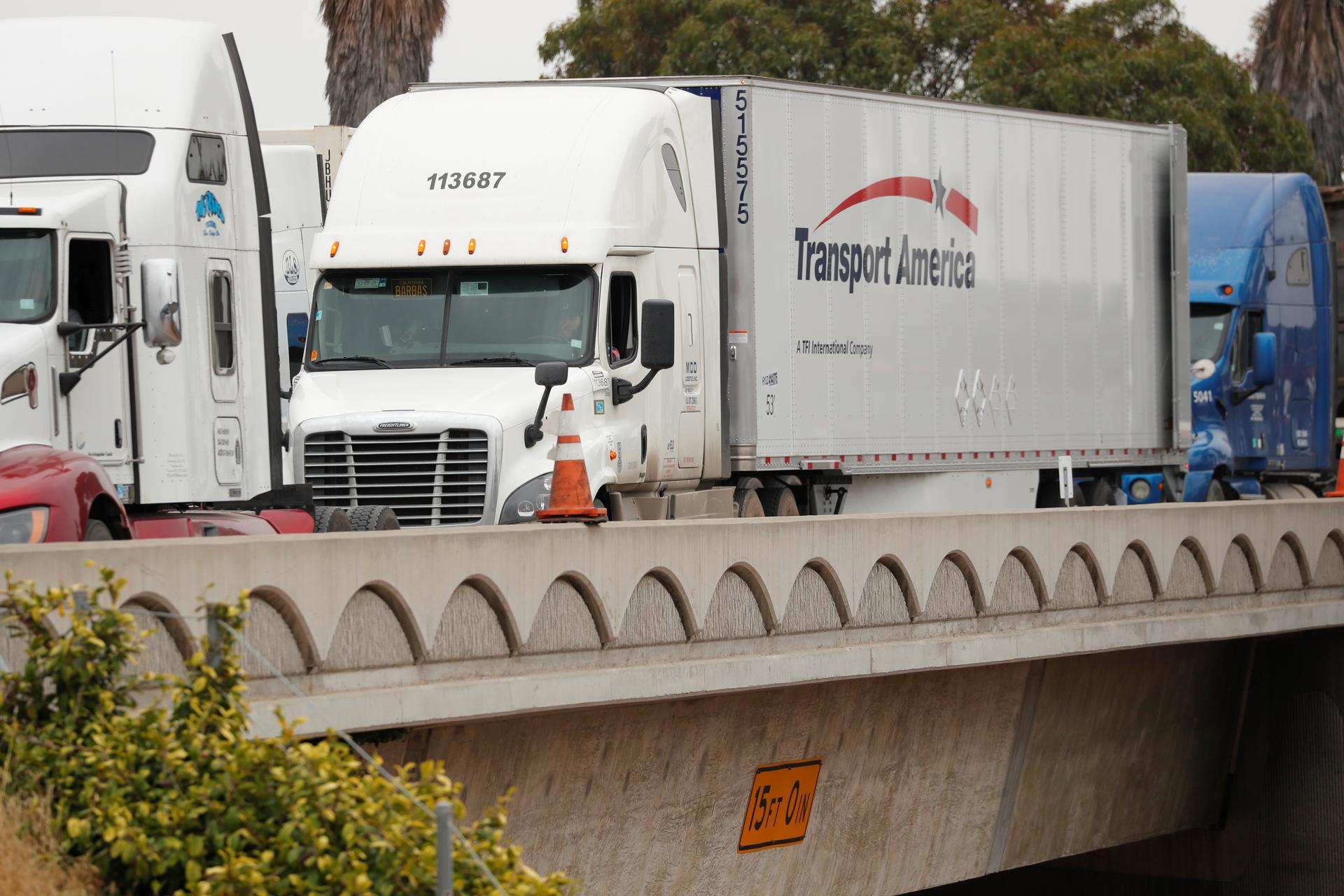 A truck crosses a bridge on the US-Mexican border. 