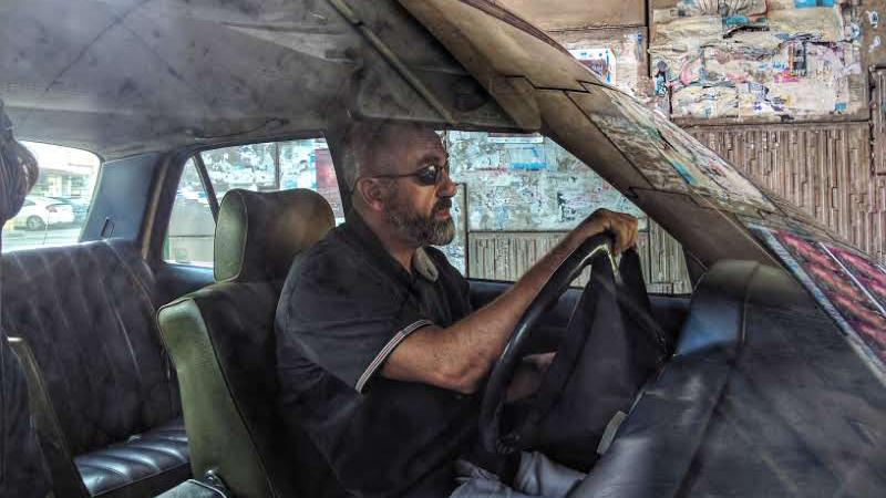 Taxi driver Gabriel Saad searches for passengers in Beirut.