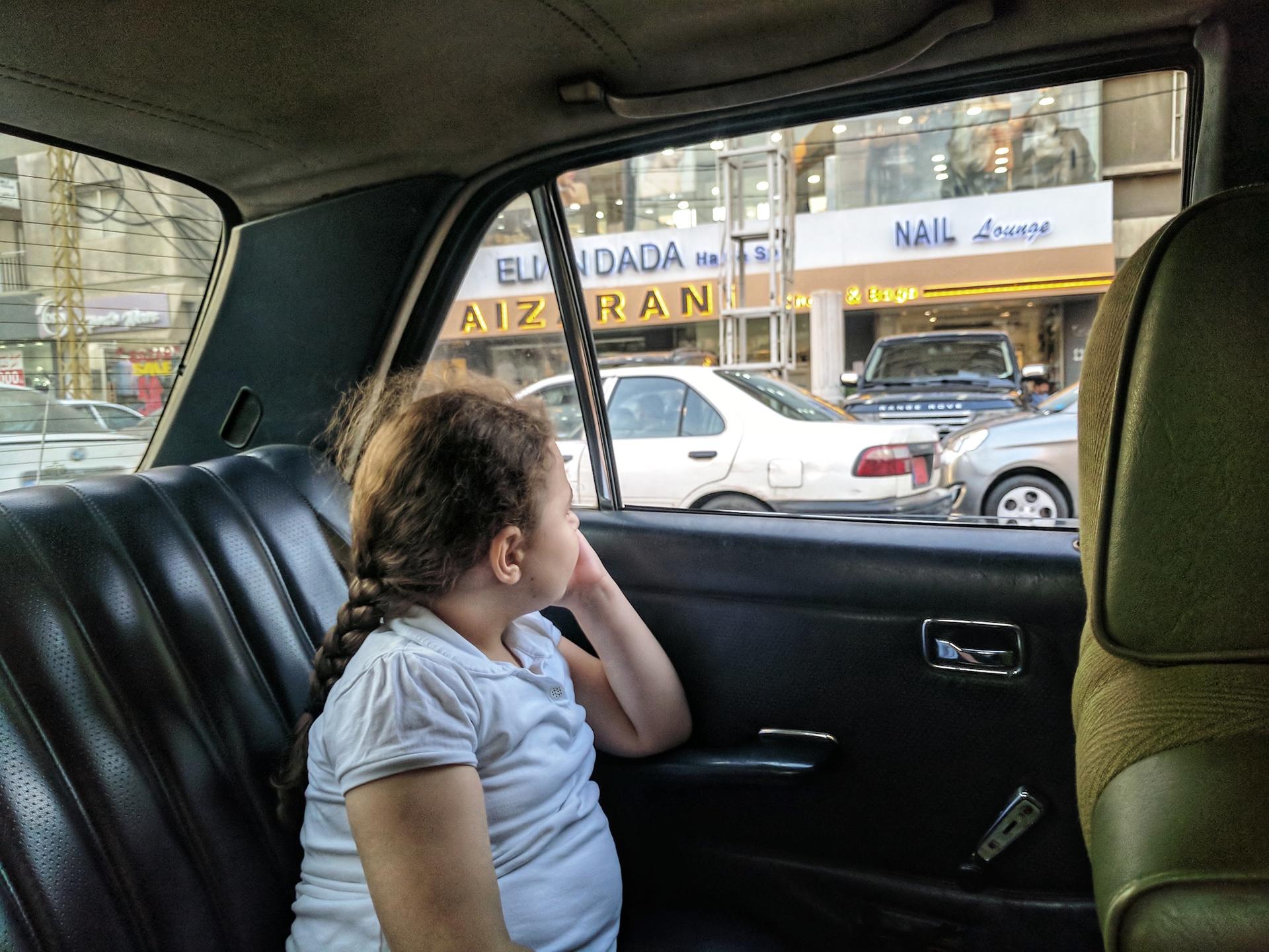 A passenger sits in a shared taxi in Beirut.