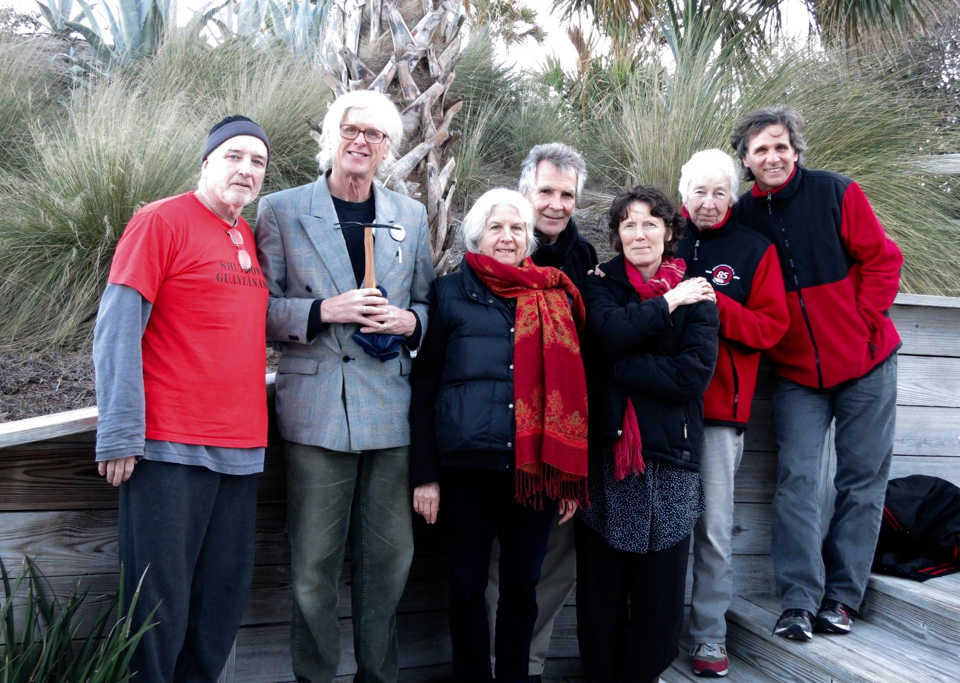 Plowshares 7 activist group poses for photograph wearing the colors red and black.