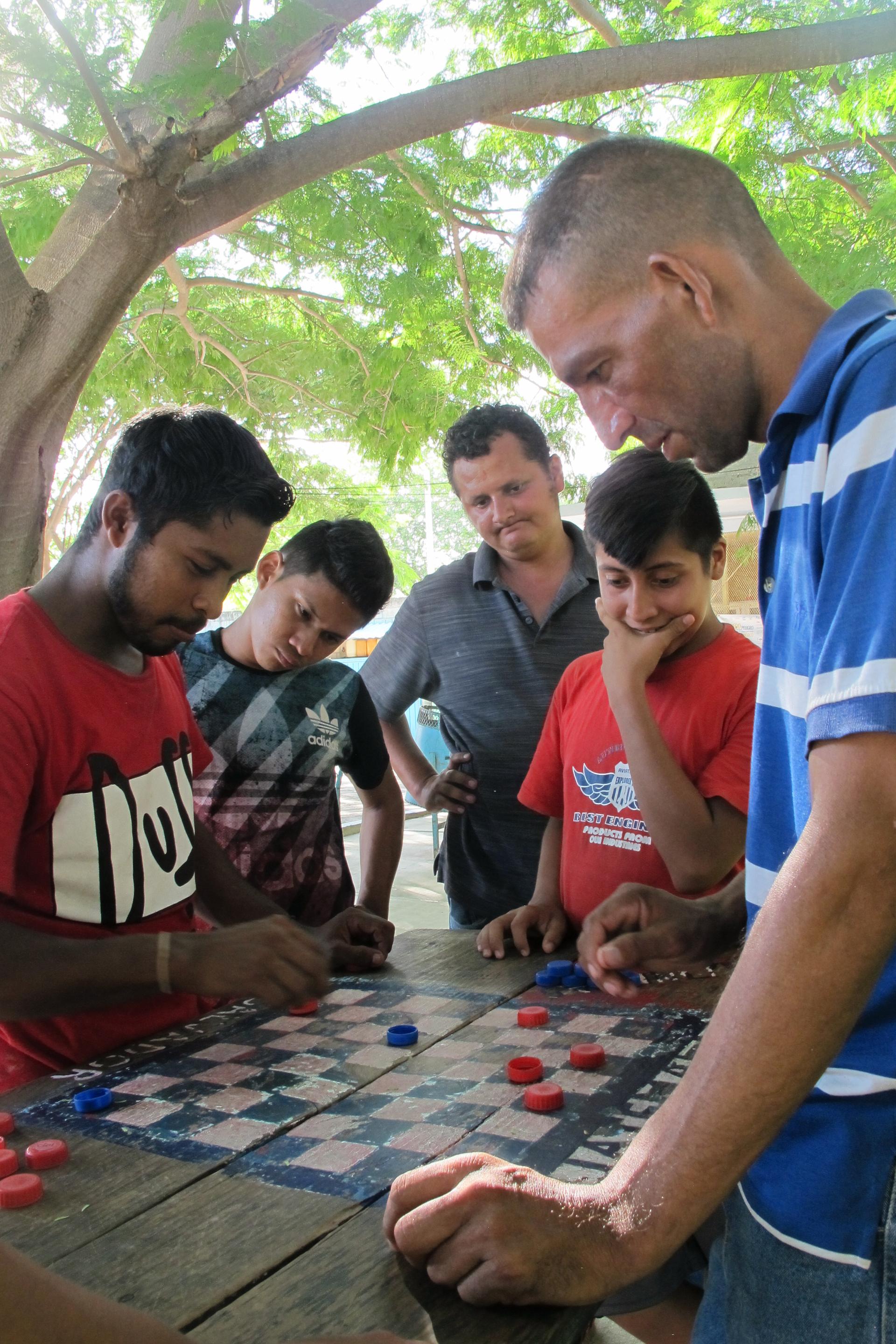 Many Central American migrants pass the days playing competitive games of checkers at the local migrant shelter in Ixtepec, Mexico. The city, as well as the surrounding region, was devastated by last September’s earthquakes.