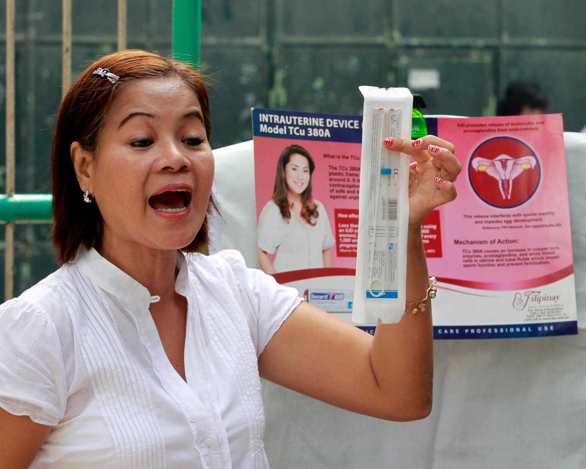 A medical worker explains a family planning method using the Intra Uterine device (IUD) to housewives in a local government health center in Navotas, Manila, March 3, 2011.